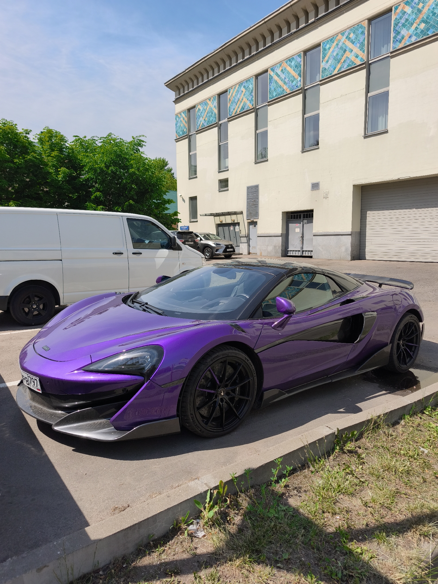Purple McLaren spotted parked near road with cycling activity
