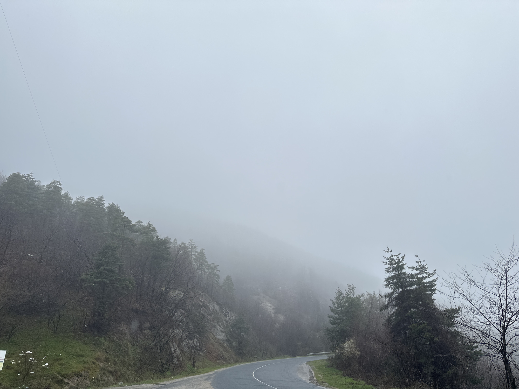 Foggy morning conditions on winding road in Komuniga Bulgaria