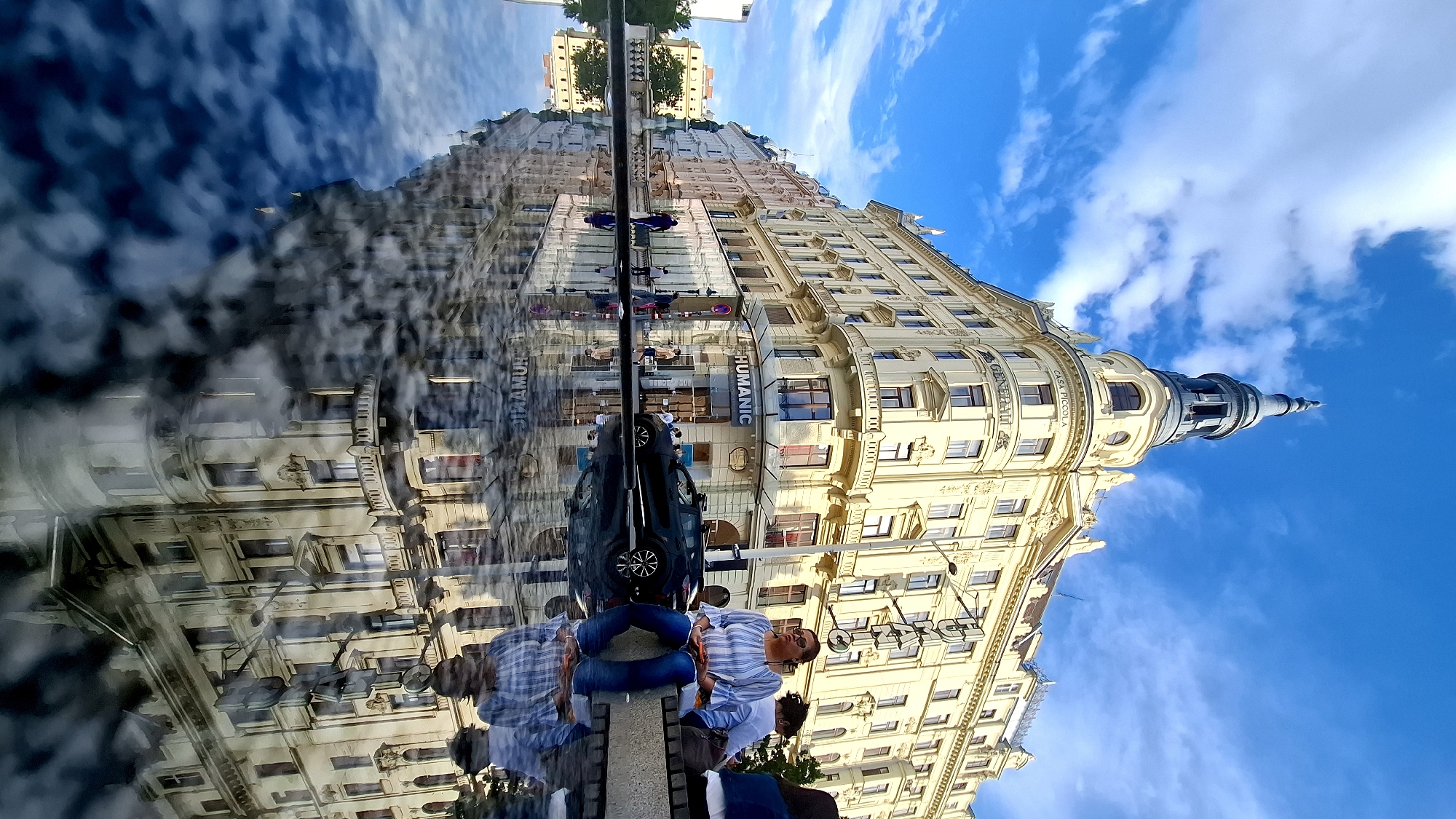 Tourist documents Vienna's Maria-Theresien-Platz museums and street performer