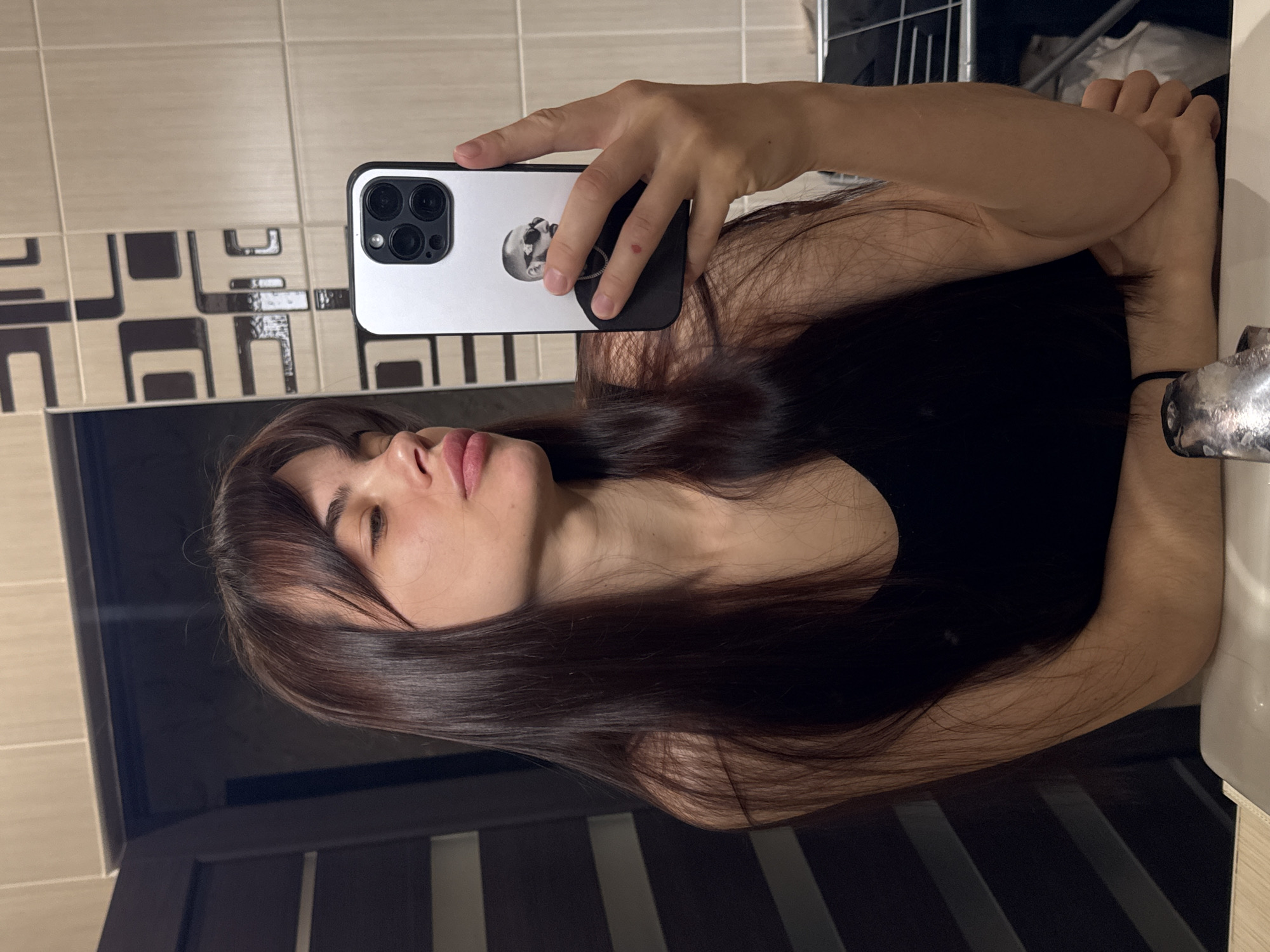 Young woman takes multiple bathroom mirror selfies in Rostov-on-Don