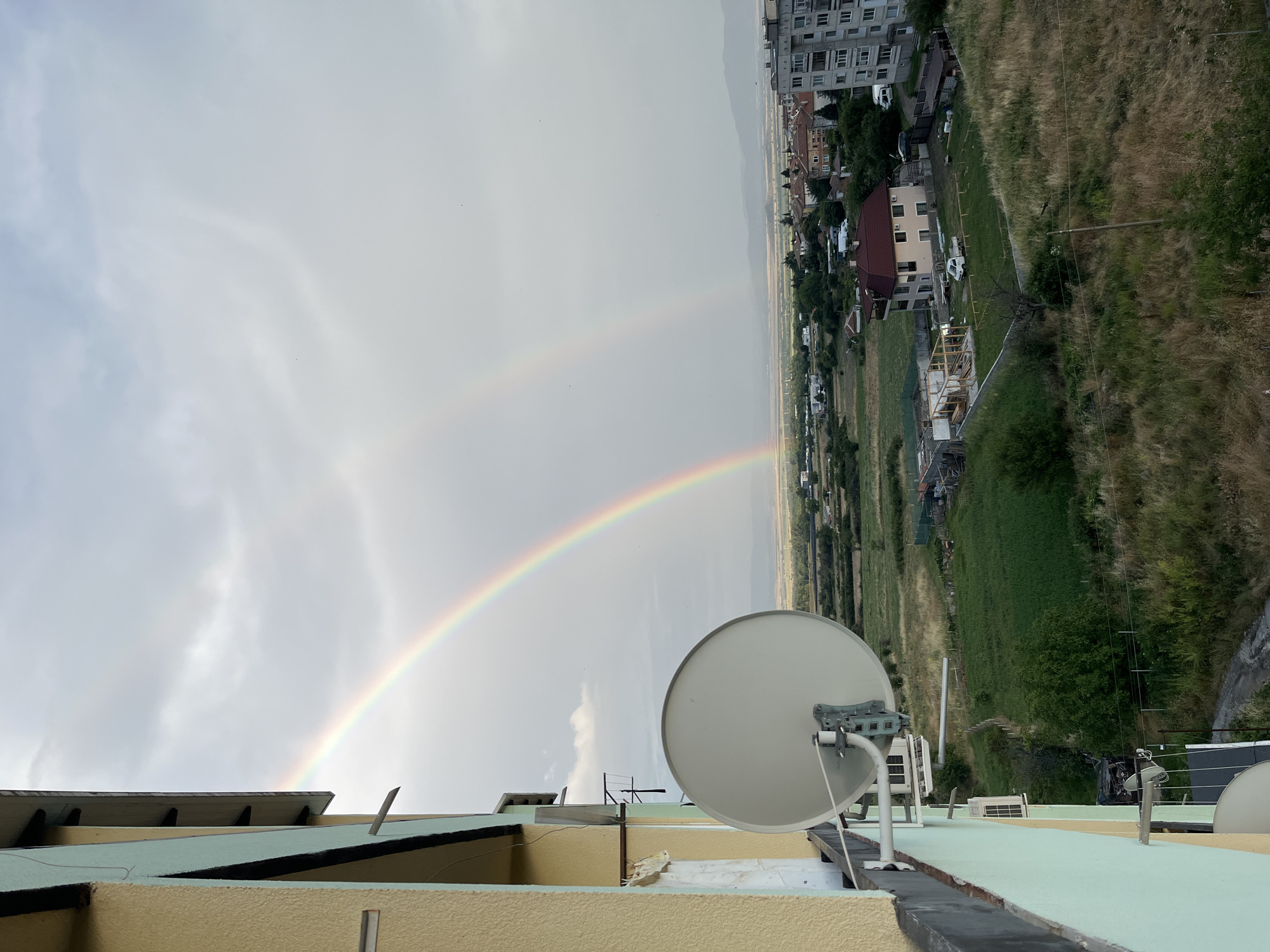Double rainbow over Sopot, Bulgaria, seen from rooftops