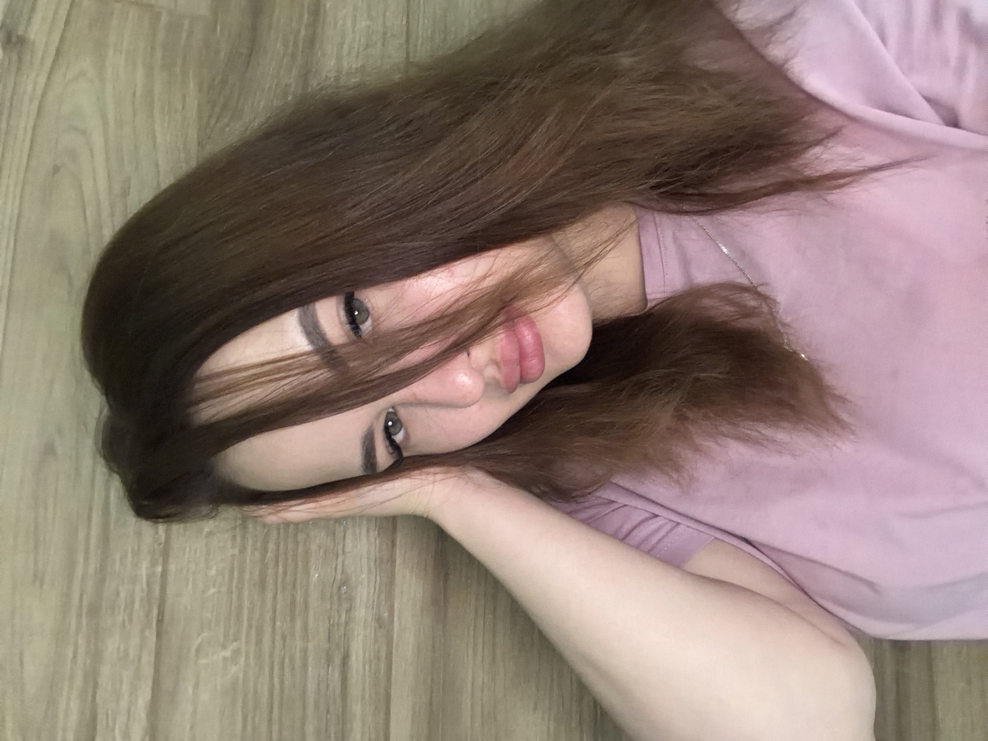Woman resting on wooden floor documented in Krasnodar