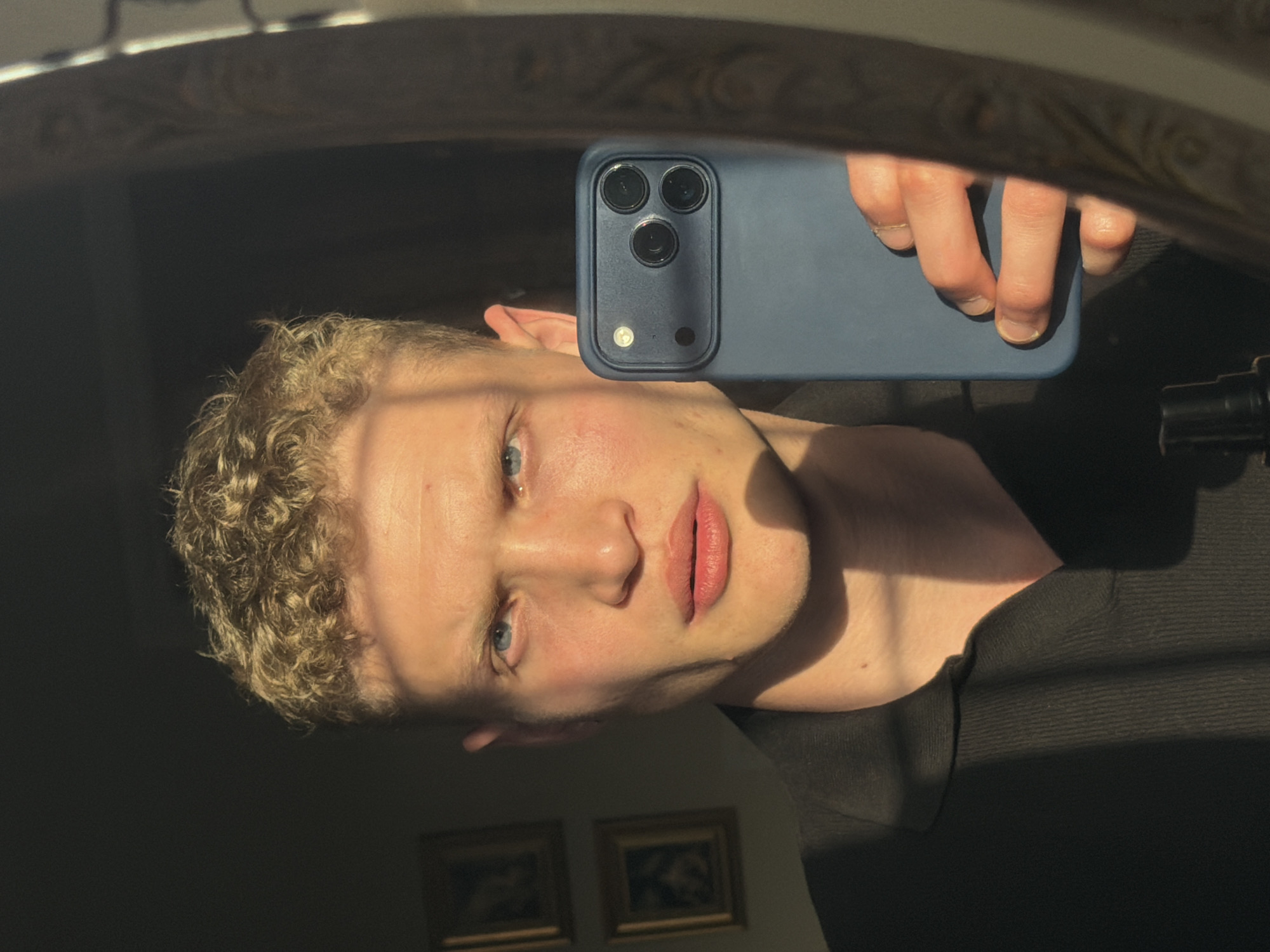 Person takes mirror selfie with smartphone in East Suffolk