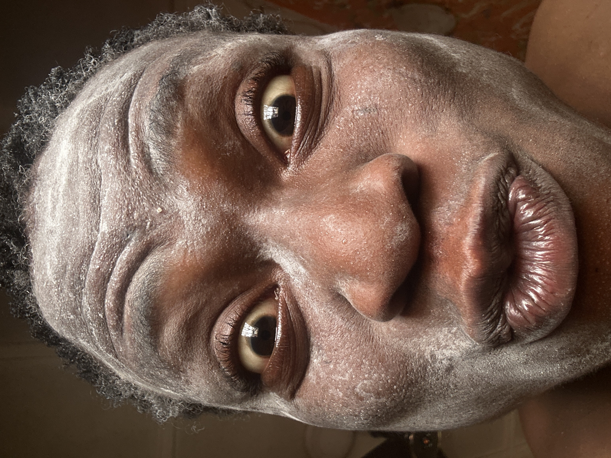 Person documents skincare routine with powder and lotion application