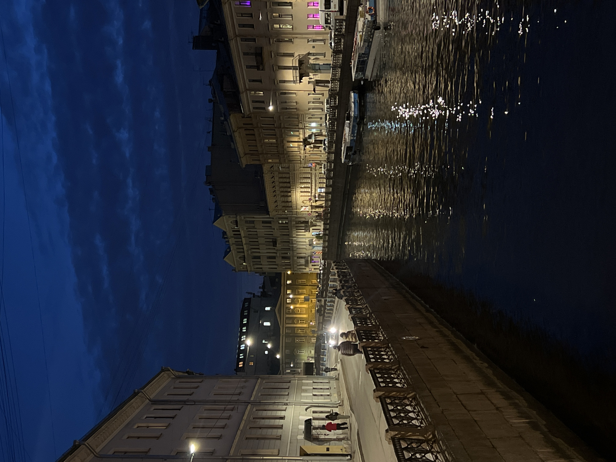 Evening lights reflect on Saint Petersburg canal waters