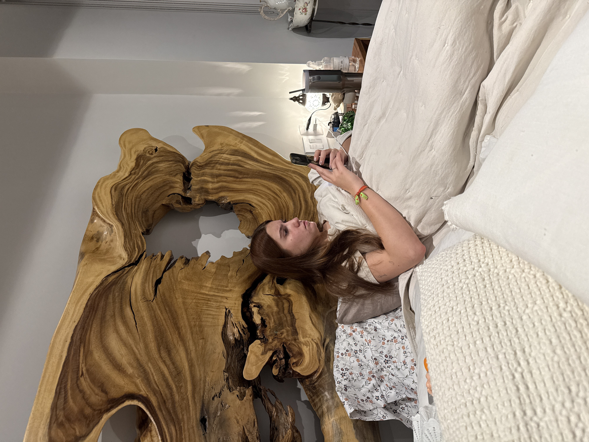 Woman uses smartphone in bed during early morning hours