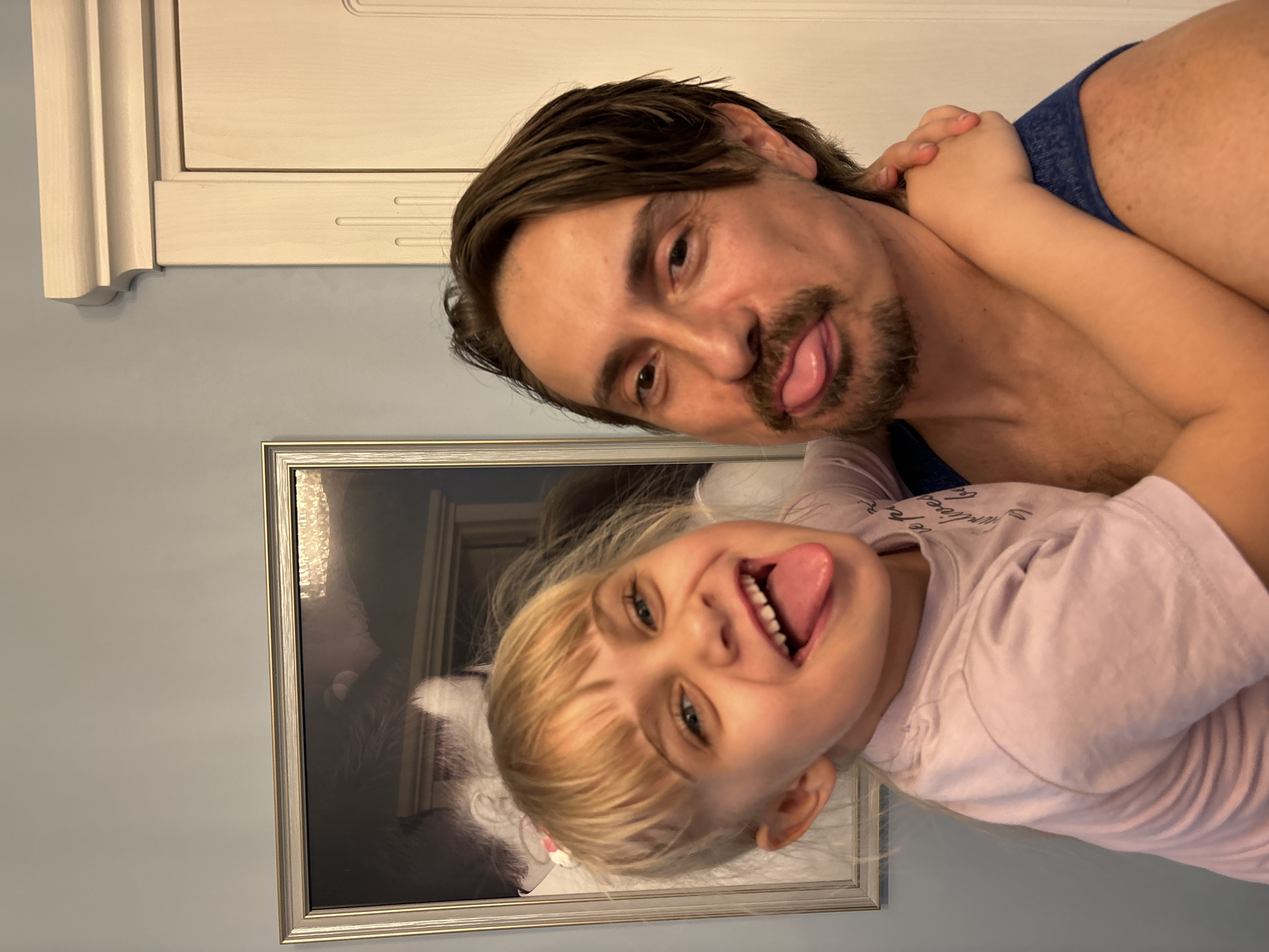 Father and daughter share playful moment in Sinyavino home