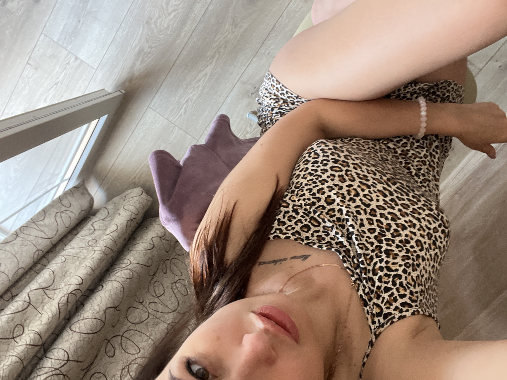 Indoor selfie session with leopard-print outfit and props