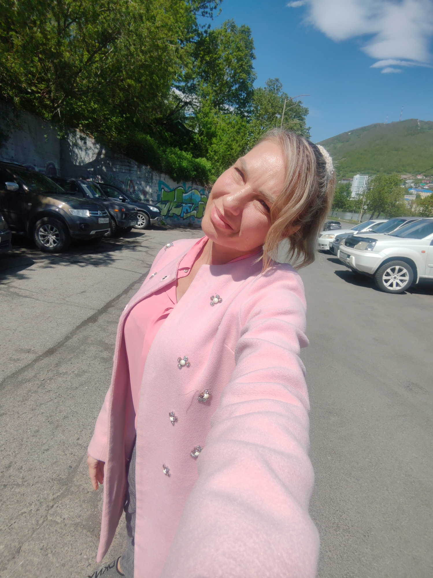 Selfie session across an office and parking lot, pink outfit throughout