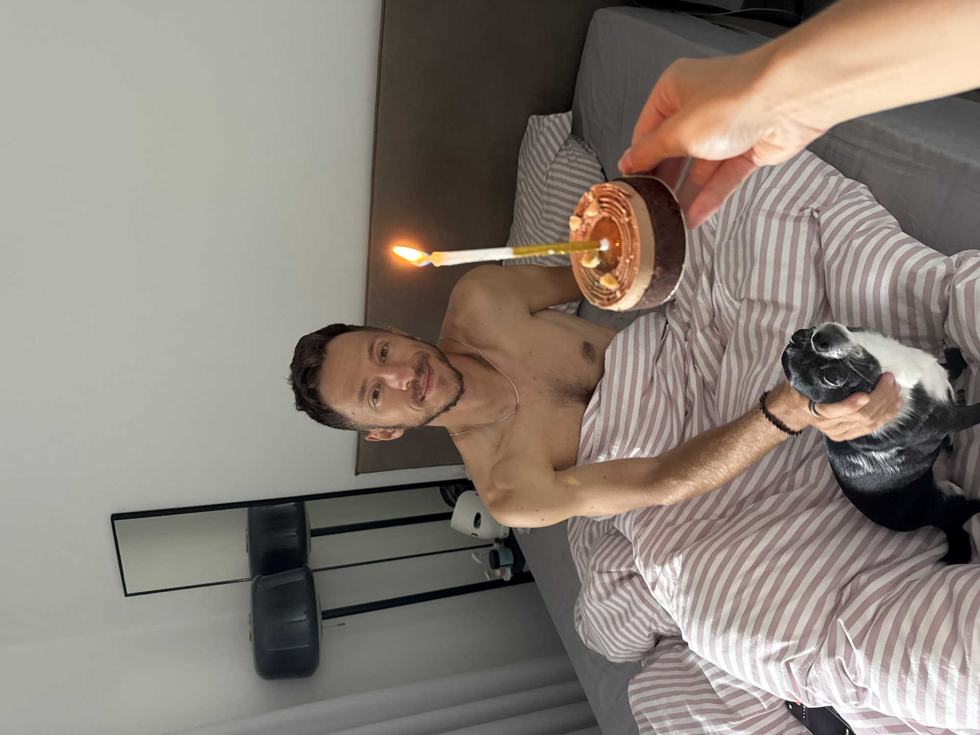 Chocolate cake with a candle, birthday morning in bed