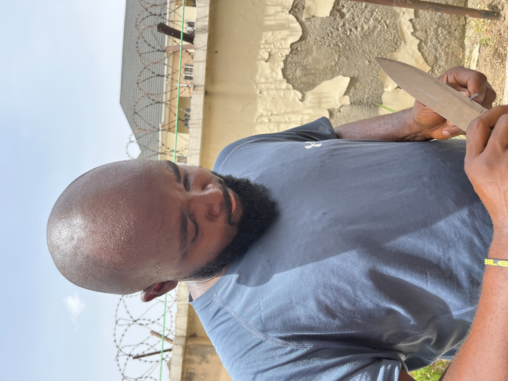Outdoor portraits captured in Kubwa Nigeria showing man with knife