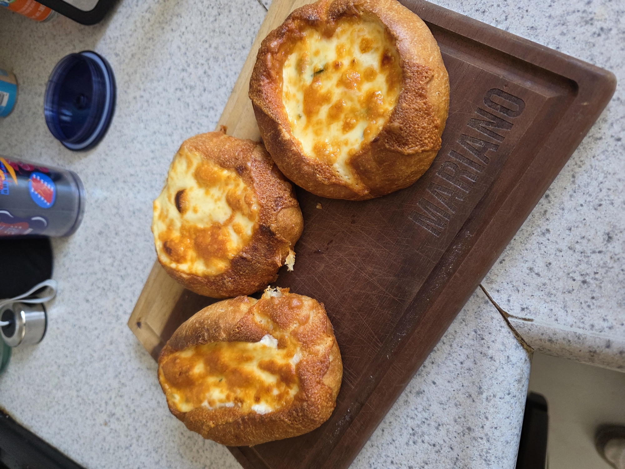 Cheese-filled pastries documented on wooden board in Puebla