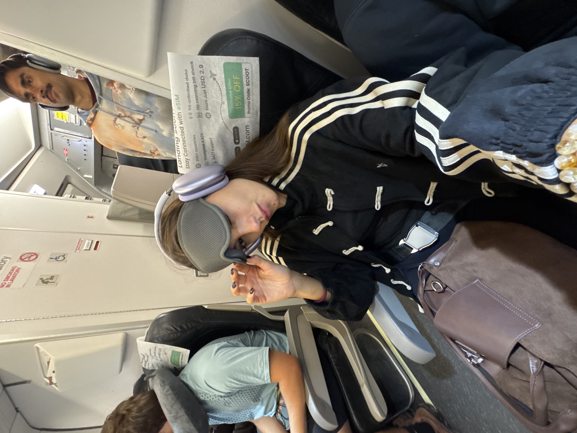 Passenger rests with eye mask during flight over Thailand