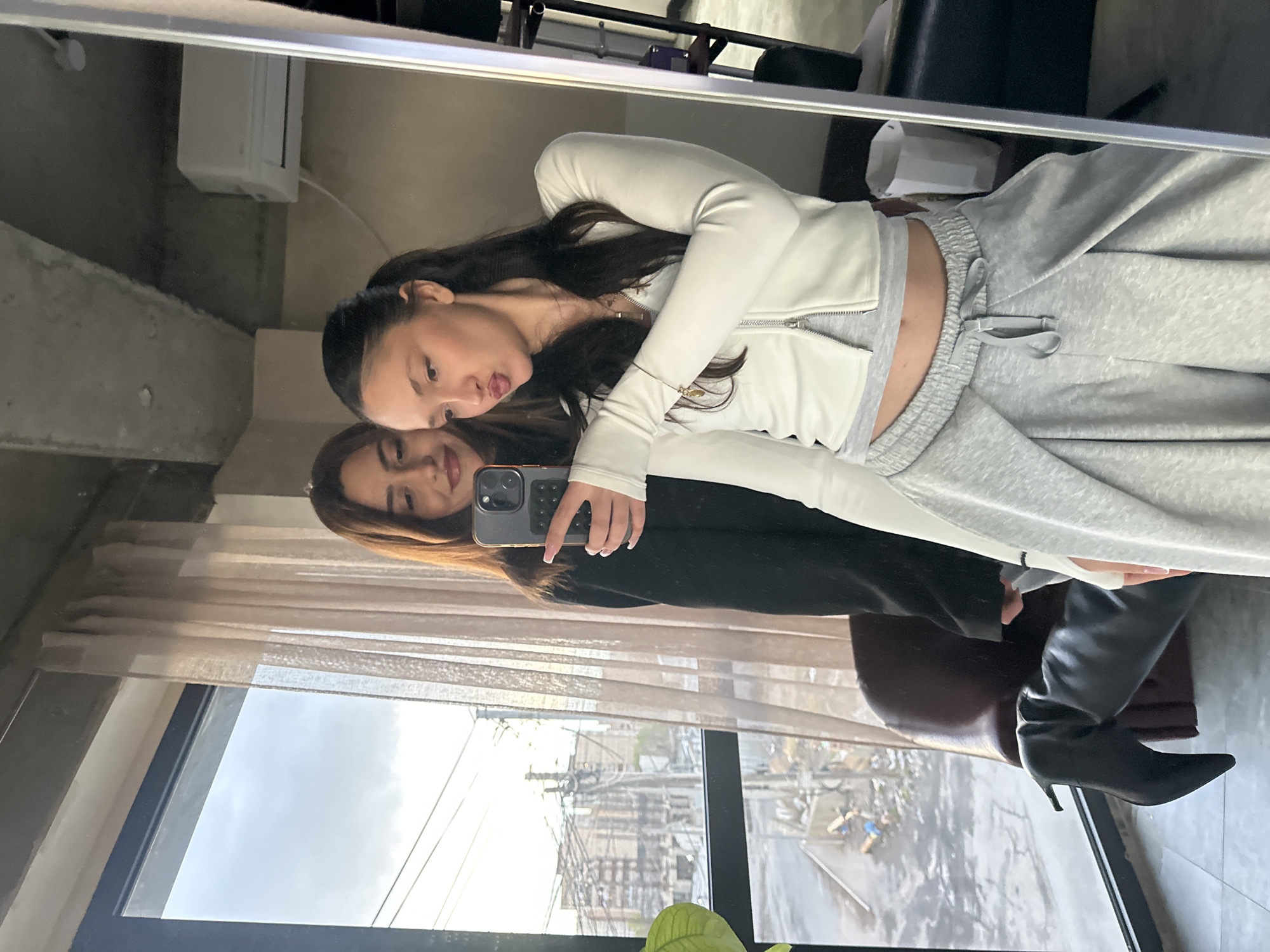 Woman takes mirror selfies in modern Zovuni interior space