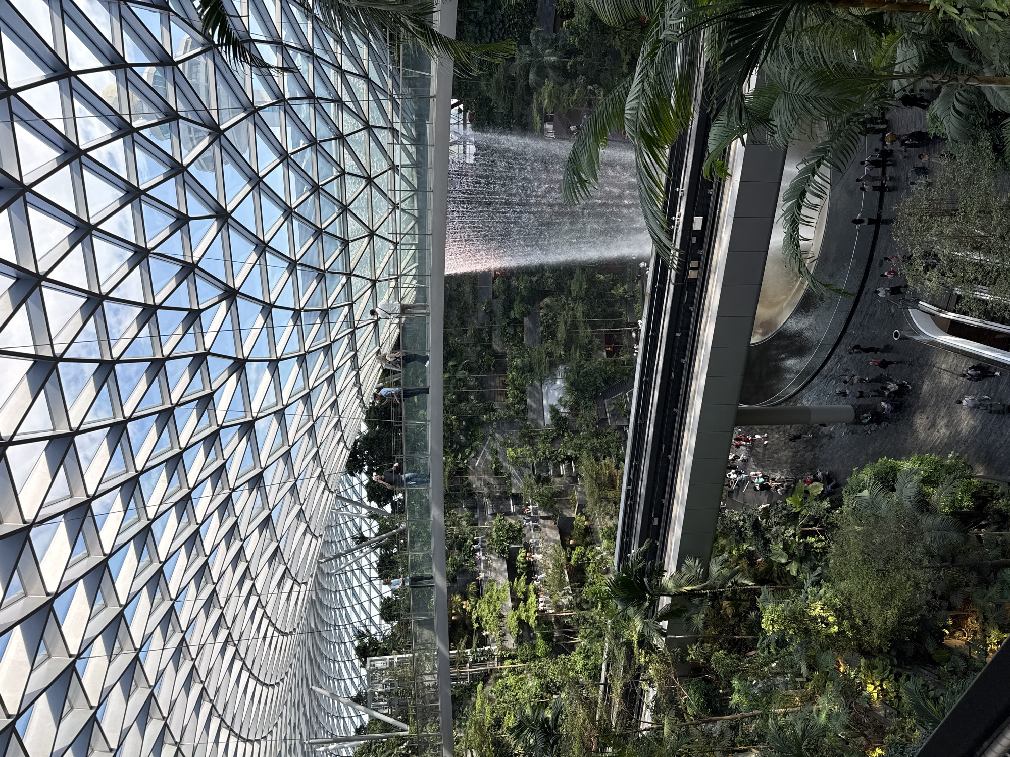 Visitors document Rain Vortex waterfall at Singapore's Jewel Changi Airport