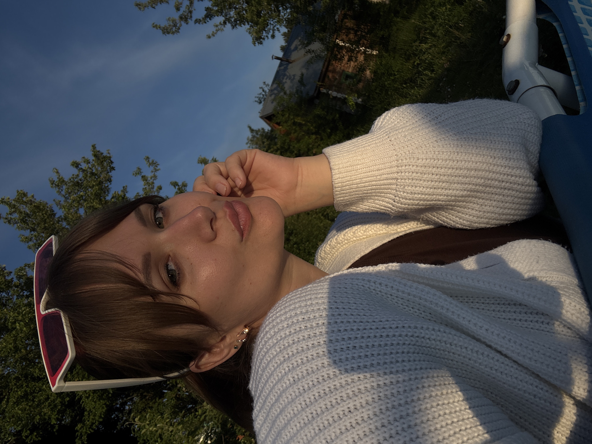 Woman enjoys poolside relaxation during golden hour in Chaikovsky