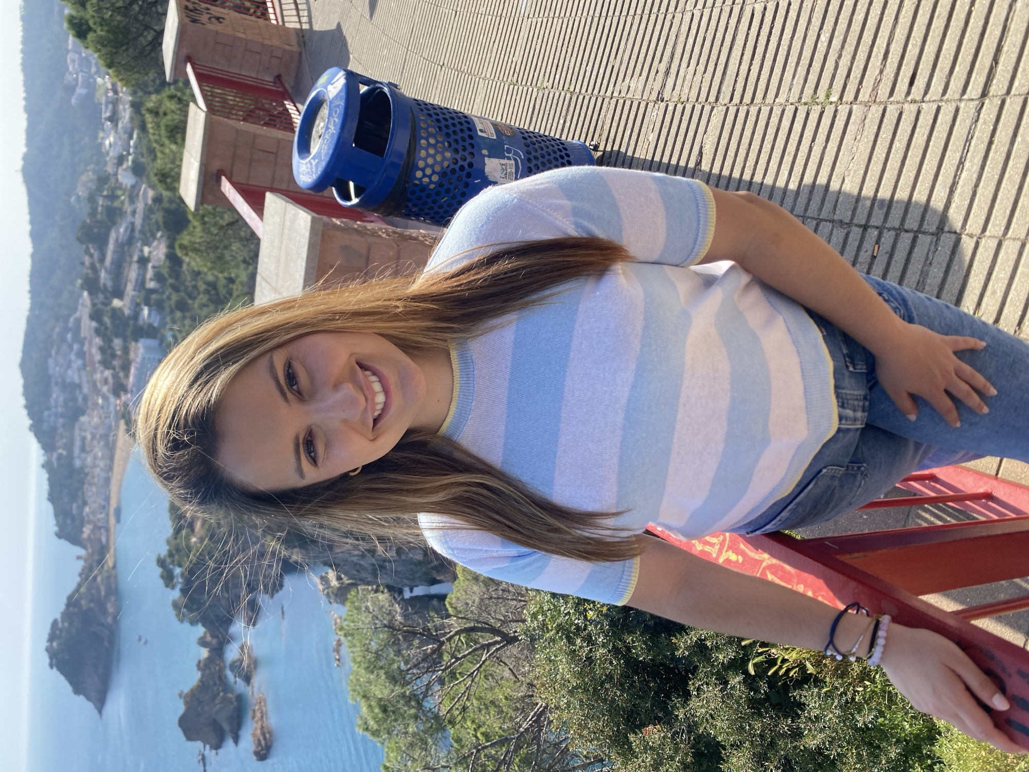 Woman poses for photo on walkway in Tossa De Mar