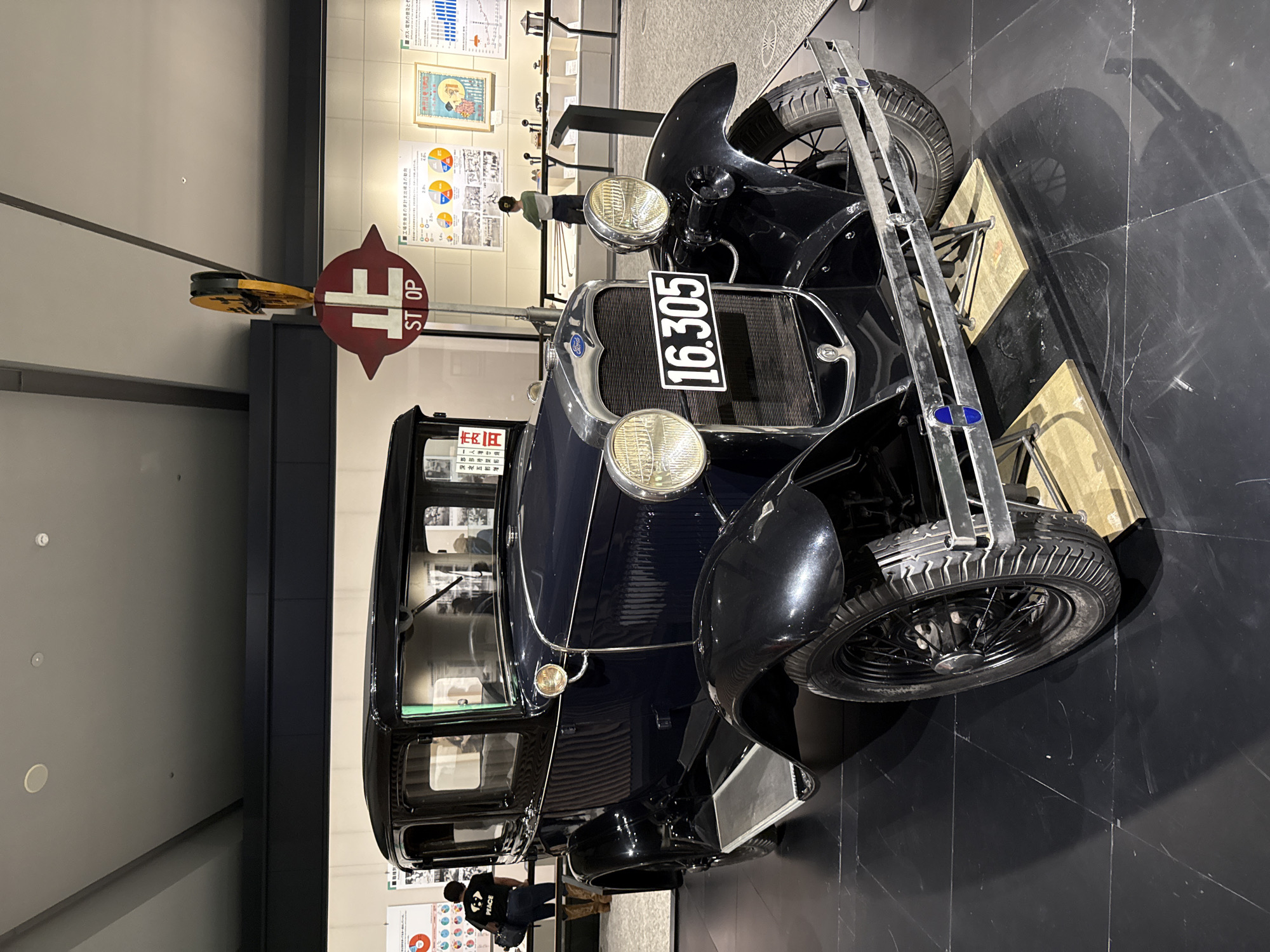Antique blue Ford displayed in museum exhibition hall