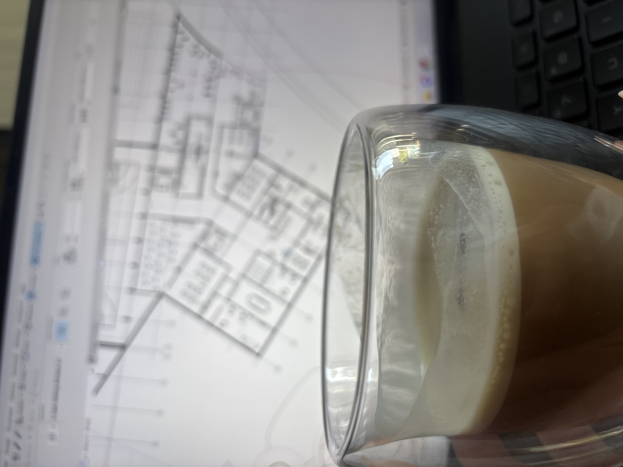 Morning coffee and architectural blueprints captured in Yerevan workspace