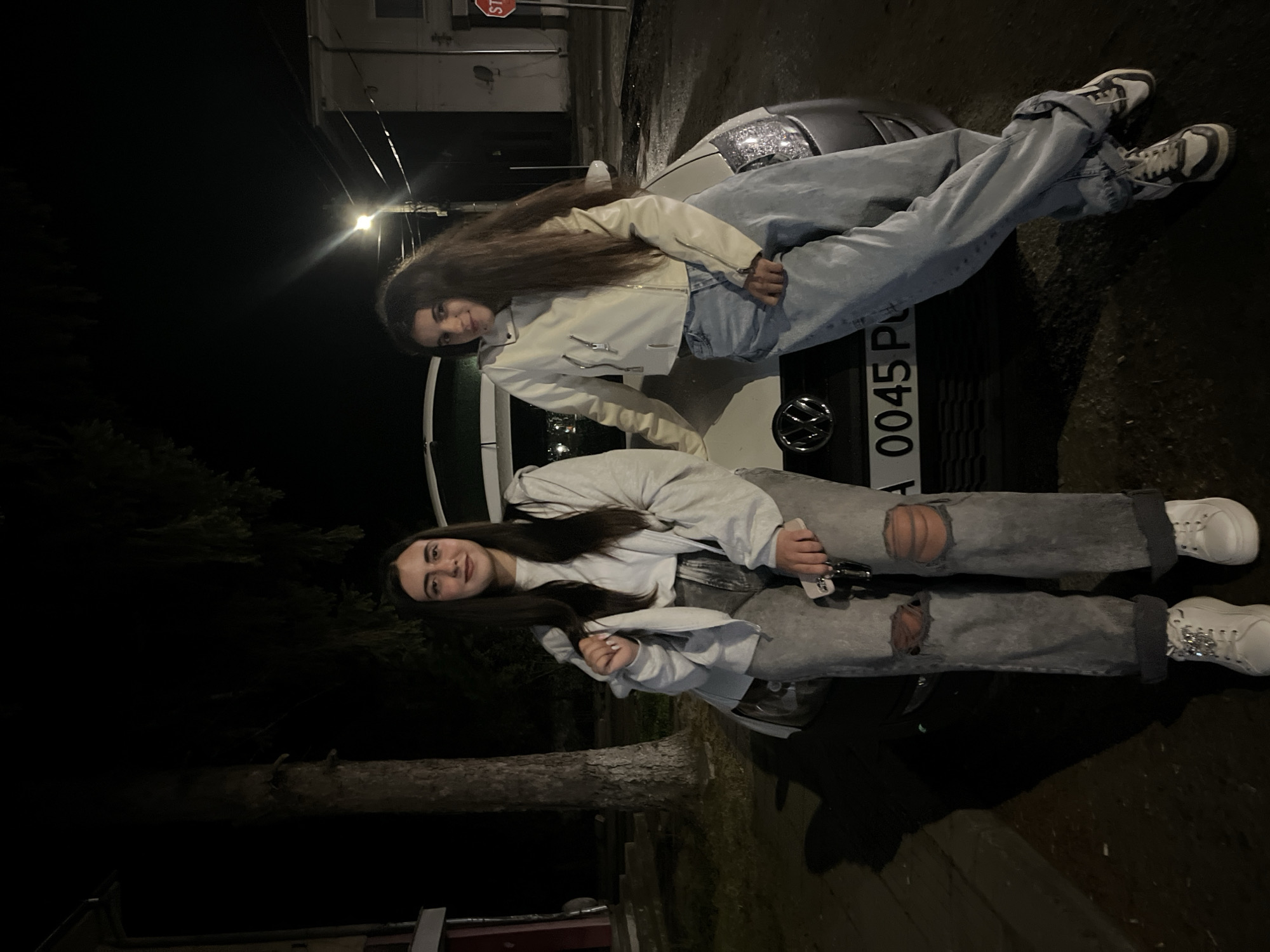 Young people pose with car during nighttime gathering in Bulgaria