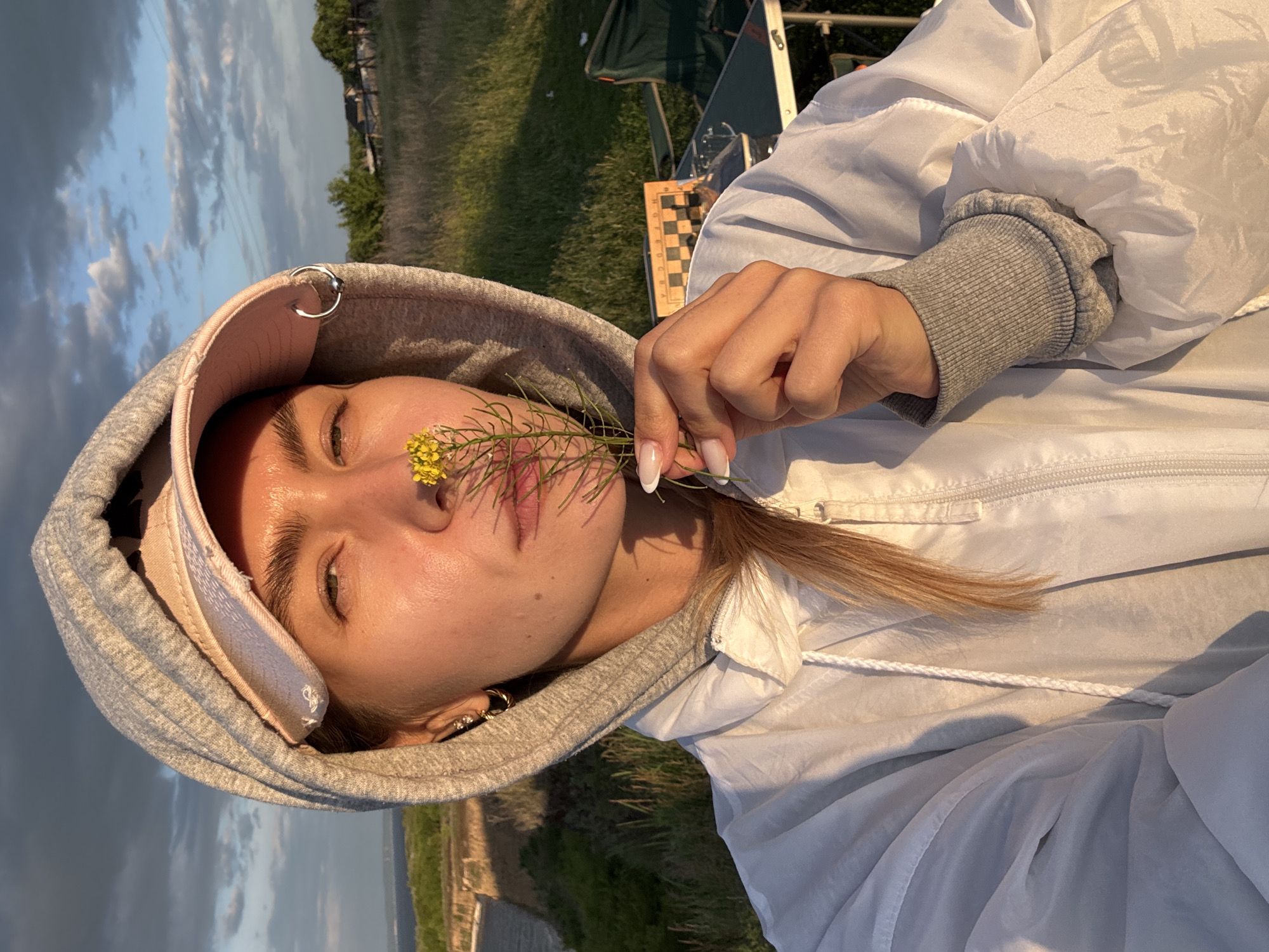 Woman takes golden hour selfies at scenic overlook