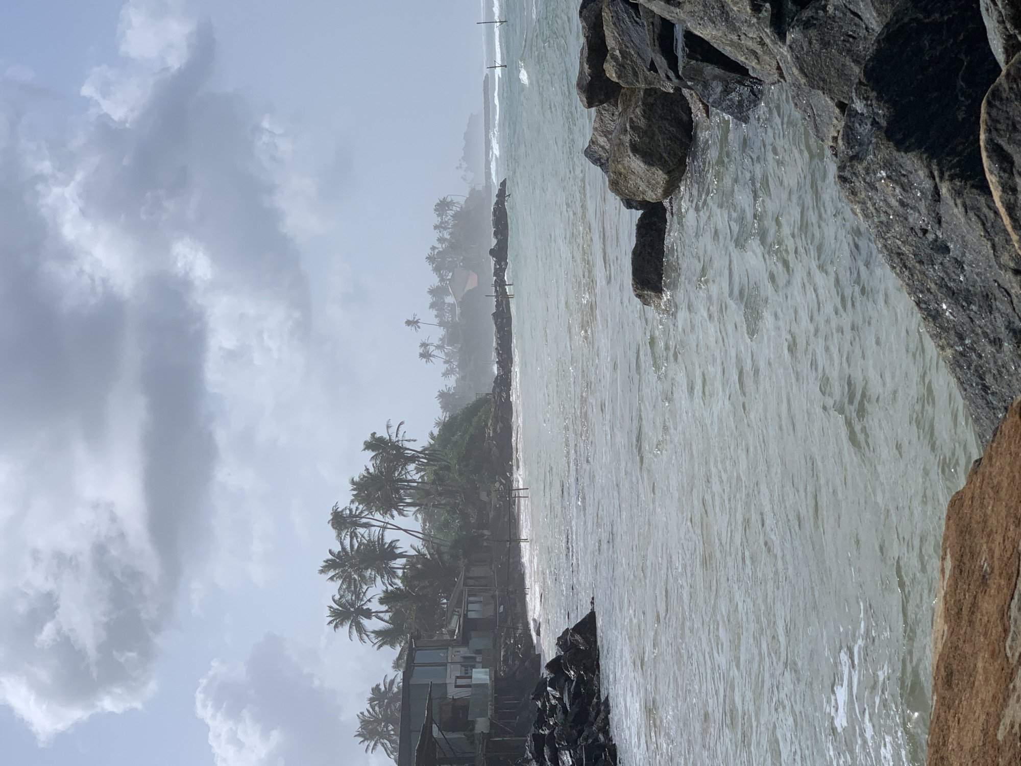 Ahangama coastline on a cloudy morning, rocks to beach