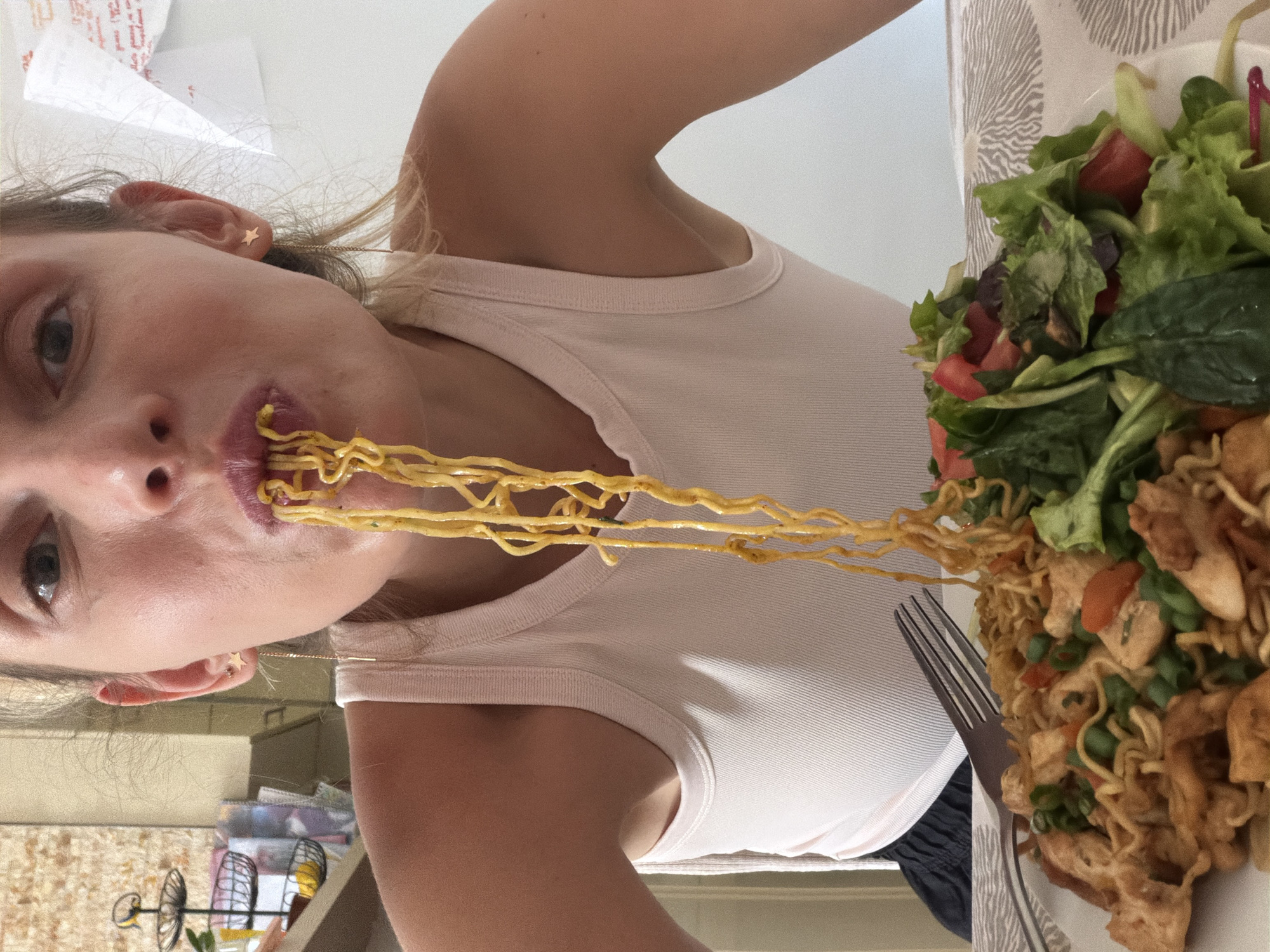 Woman enjoys noodle lunch in Budva restaurant