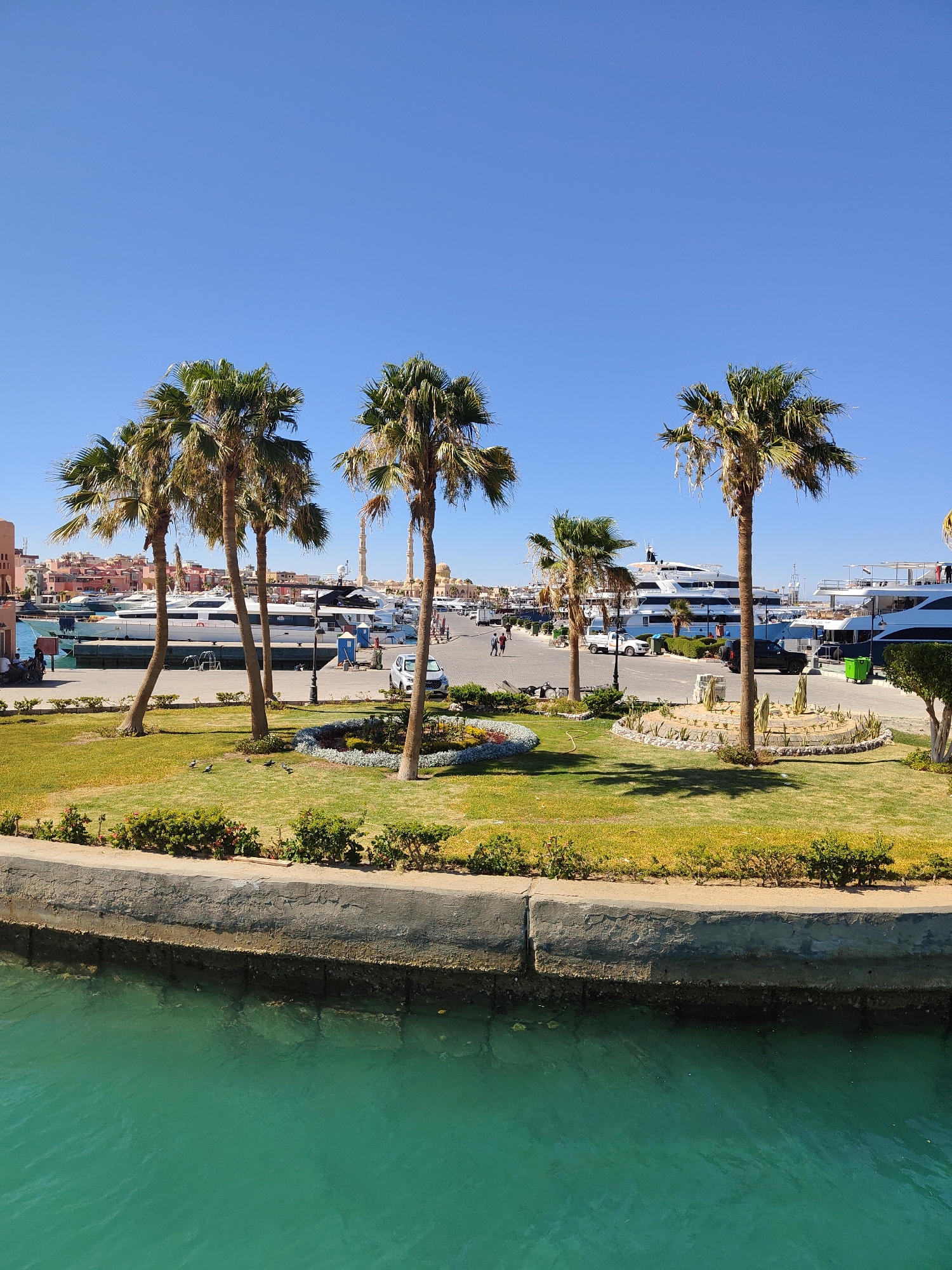 Hurghada marina on a sunny afternoon, yachts docked and calm.