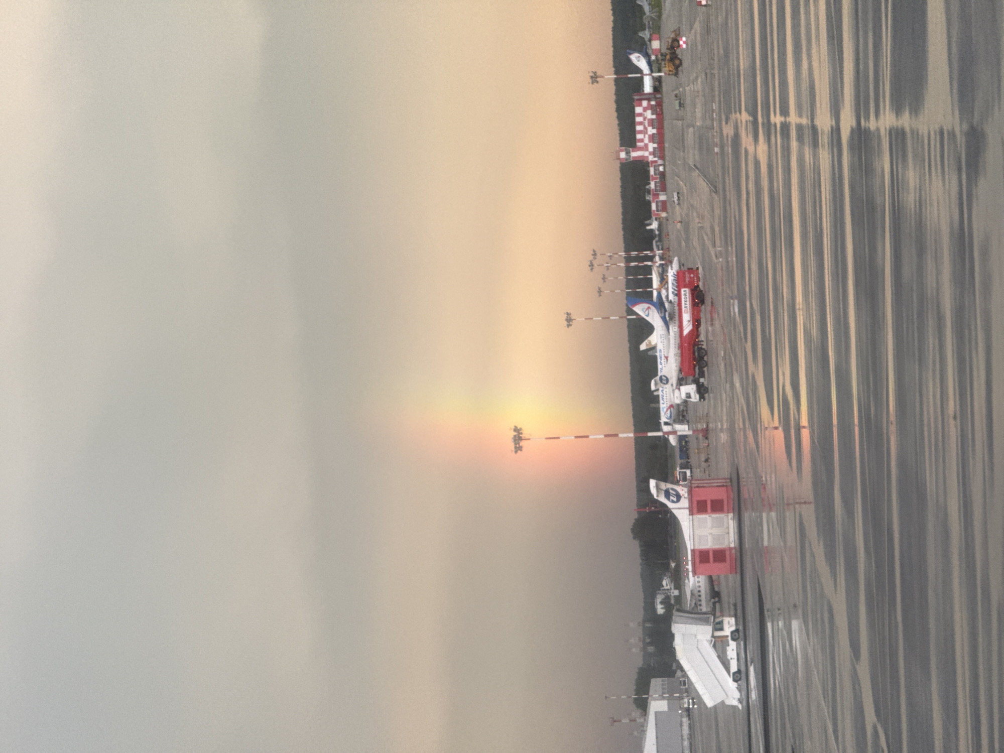 Rainbow over a wet Koltsovo Airport tarmac after summer rain