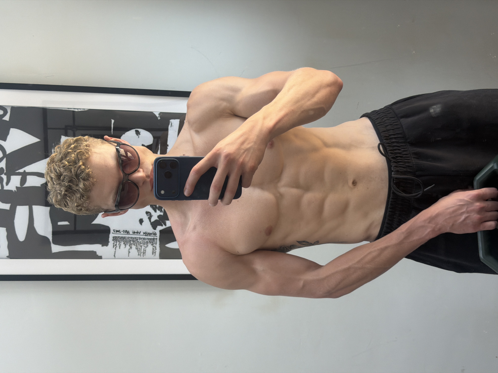 Mirror selfie in a London home gym, July 2026