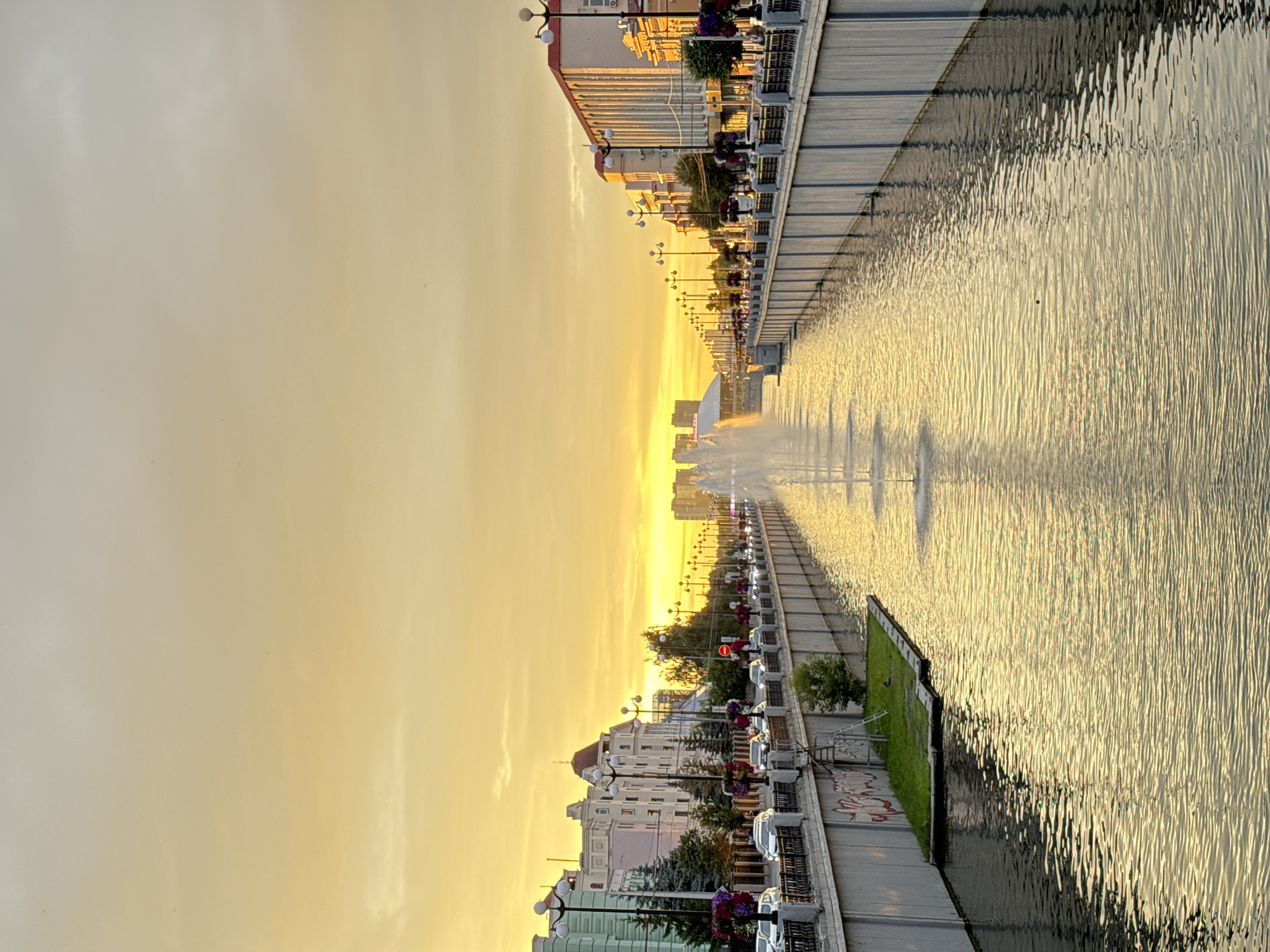Kazan canal at sunset, framed by blooming petunias