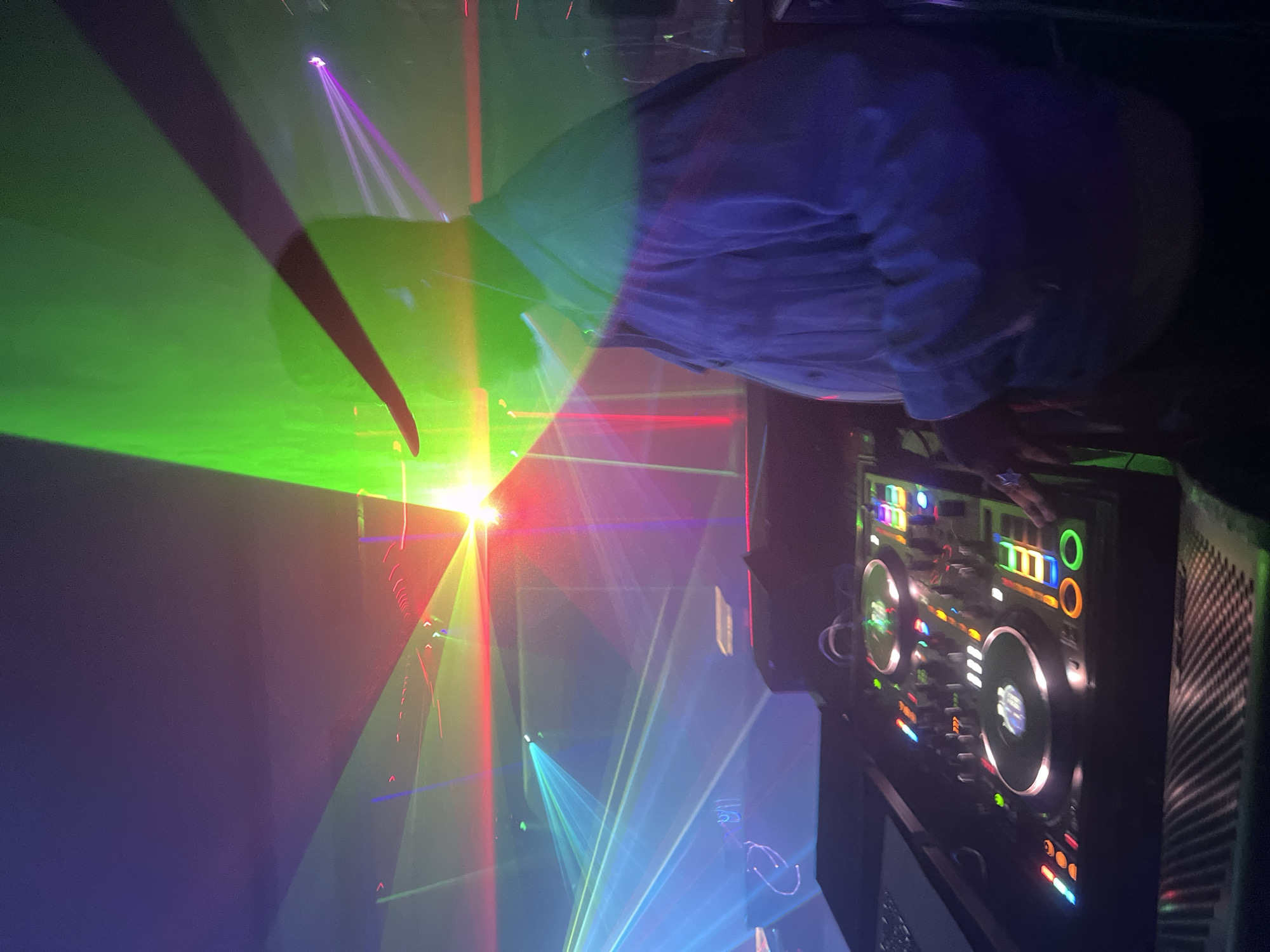DJ performs with colorful laser light show at club