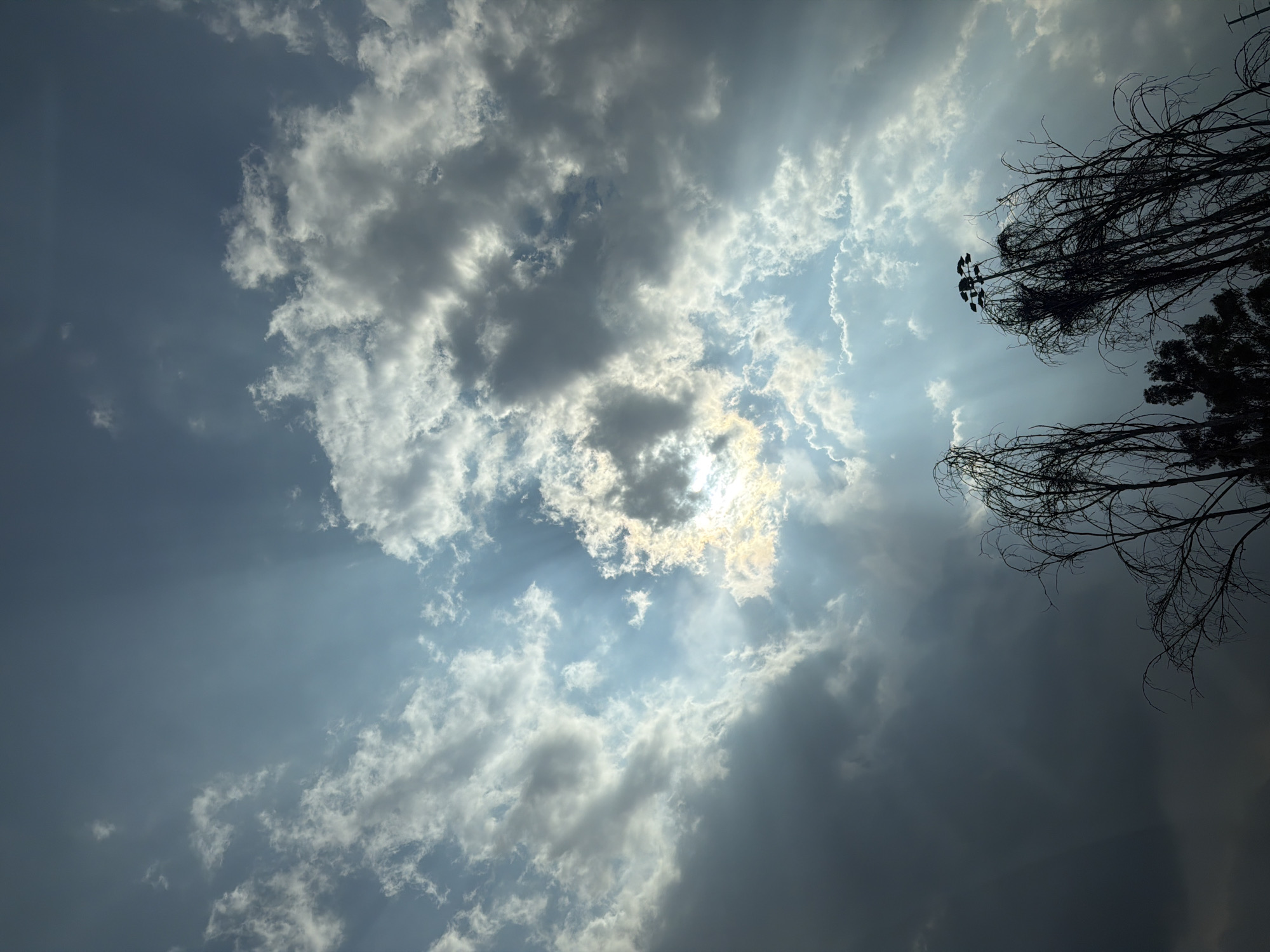 Witness captures sun rays breaking through clouds creating halo effect