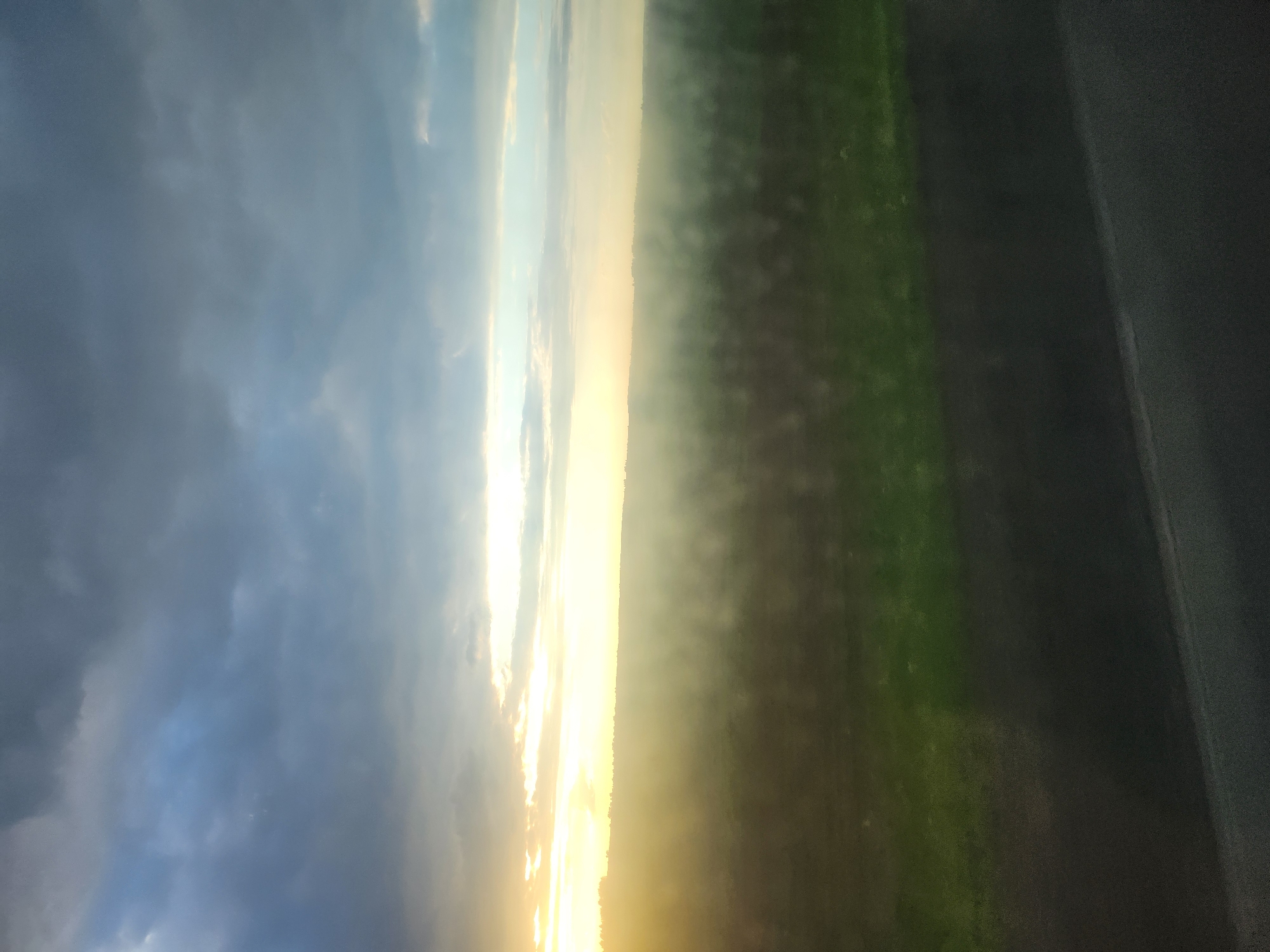 Sunrise or sunset landscape observed with golden light band