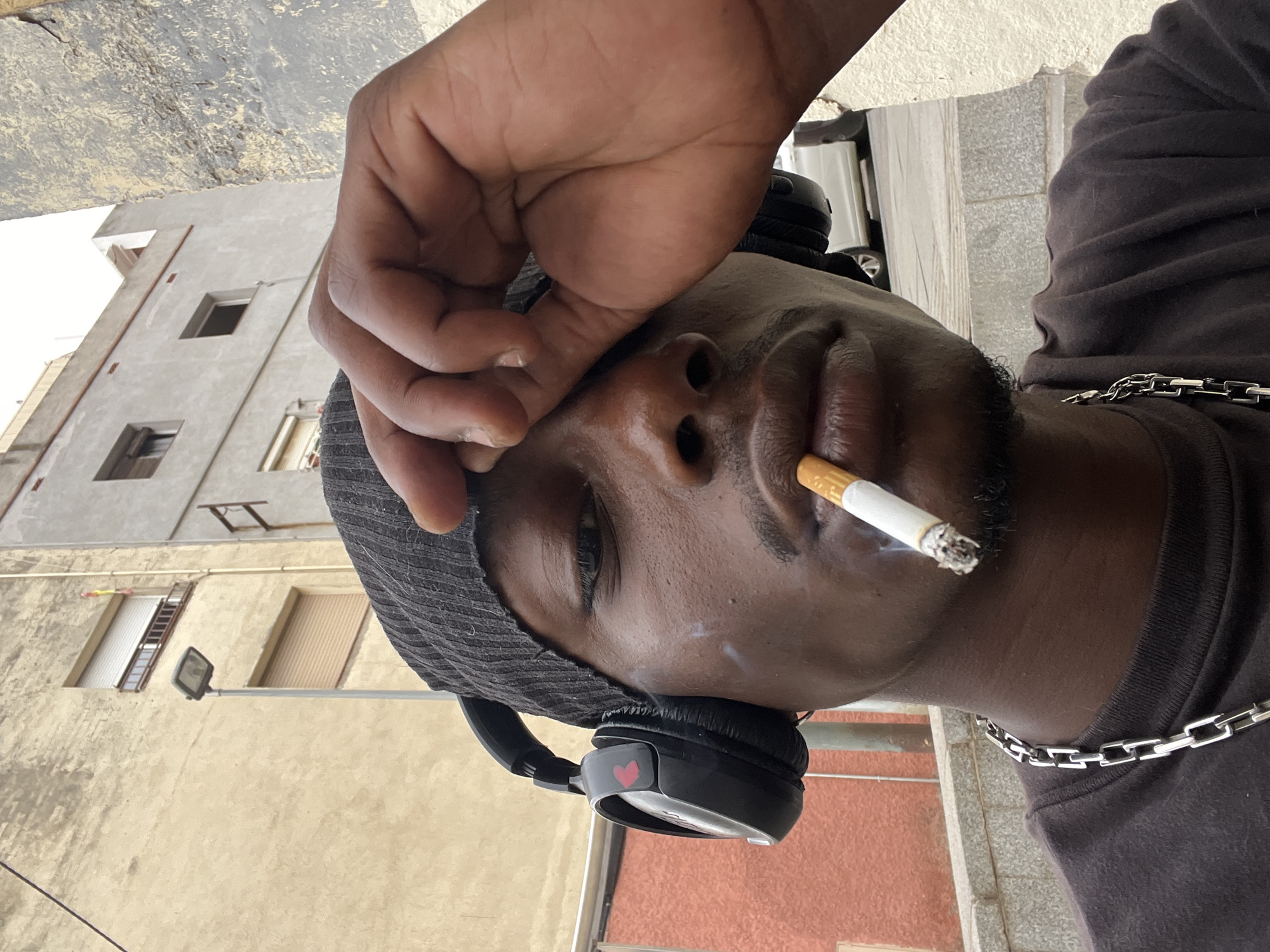 Man smoking, posing for photos in Barcelona streets