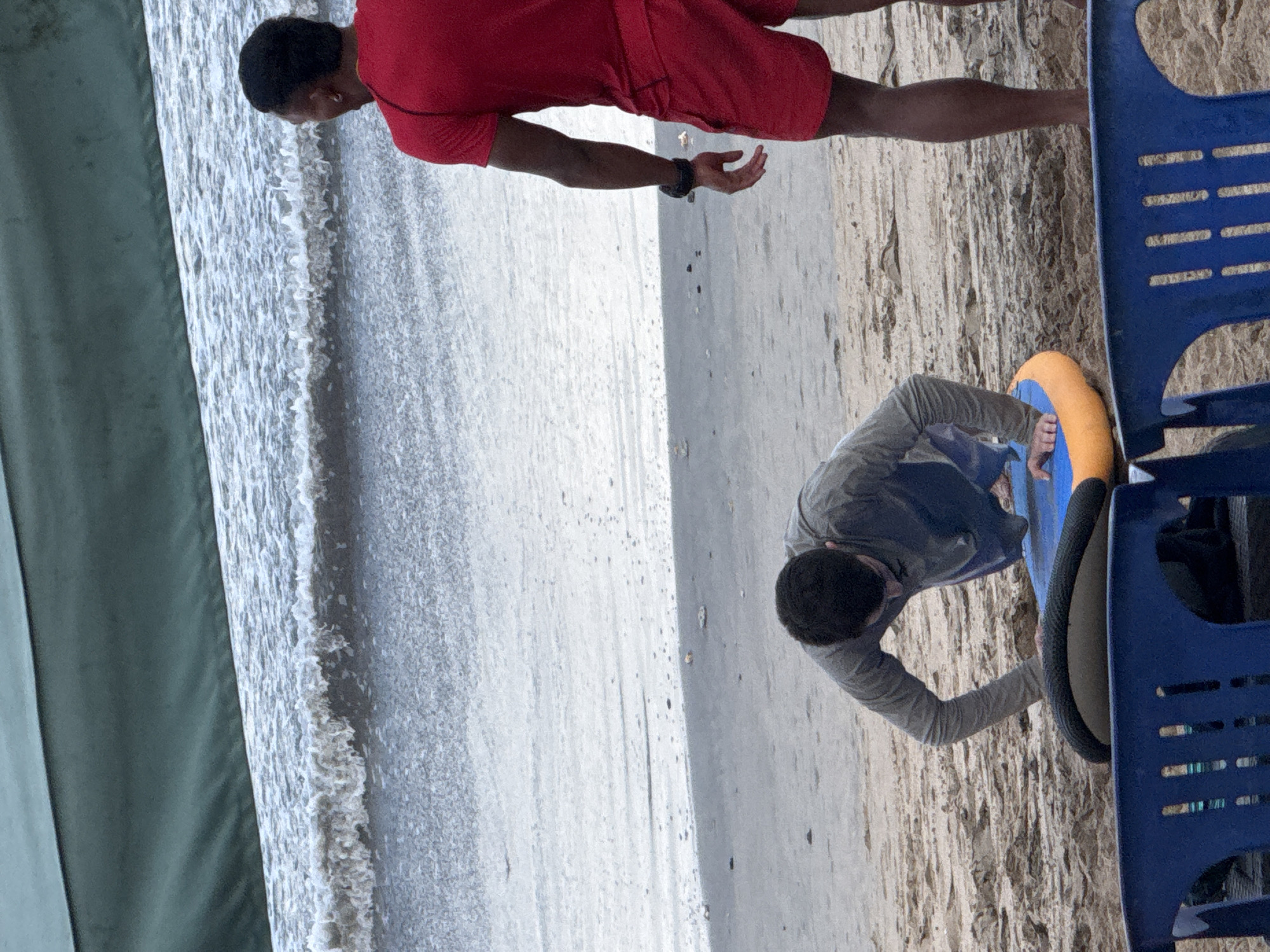 Surfboards and activity on a cloudy Kuta Beach morning