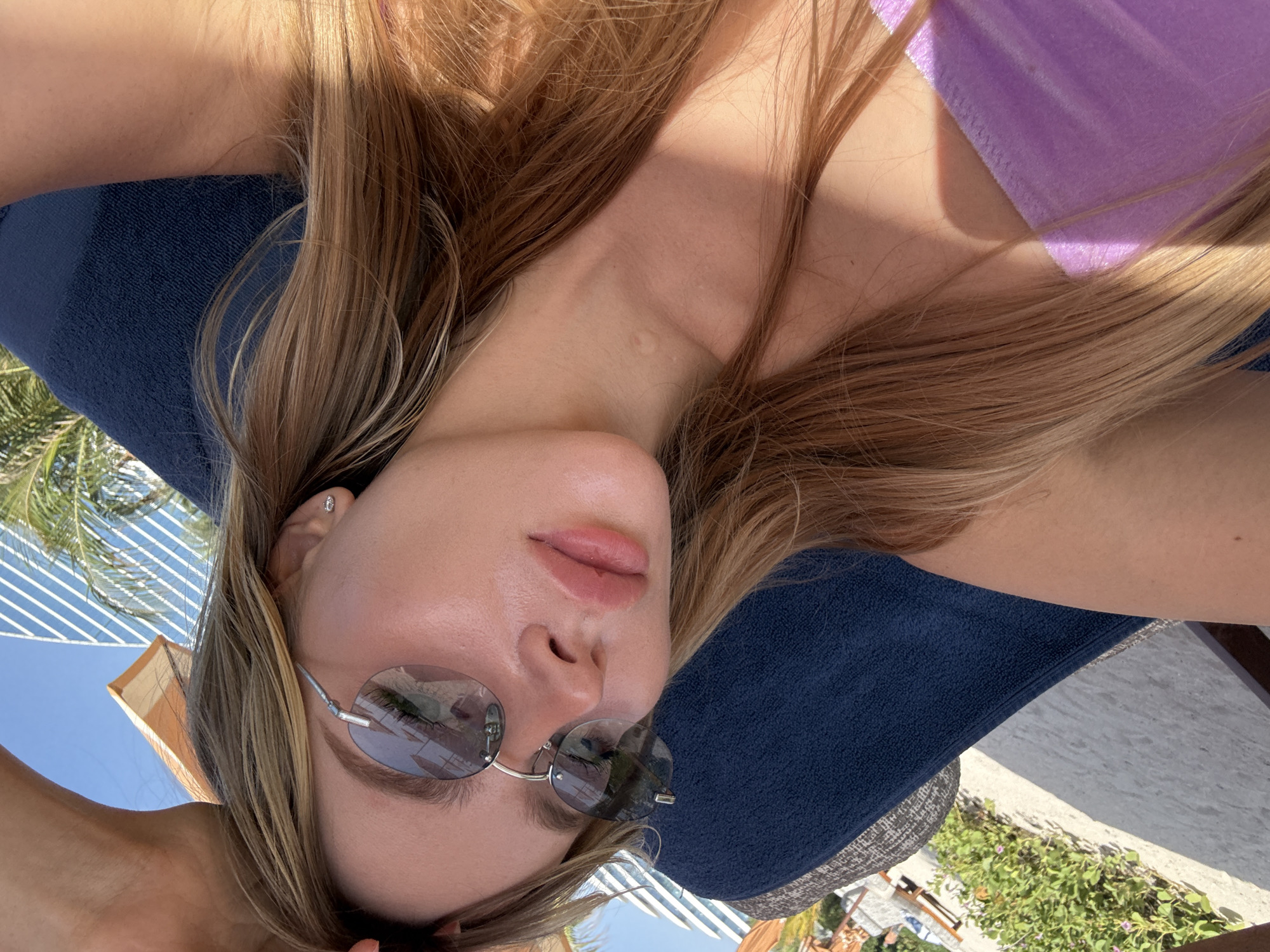 Woman sunbathes at Dubai beach with Burj Al Arab backdrop
