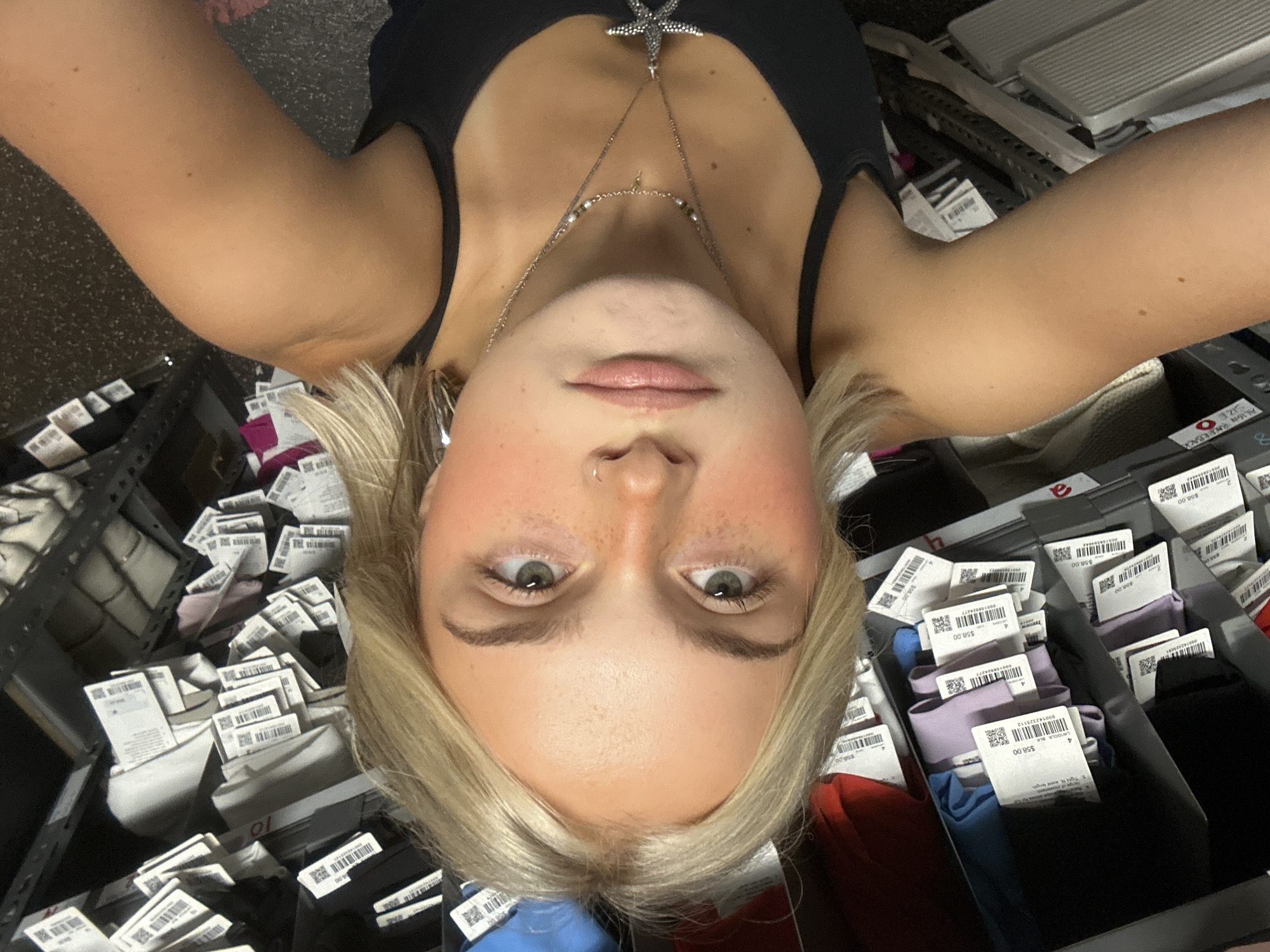 Woman takes selfies in Whistler retail store stockroom