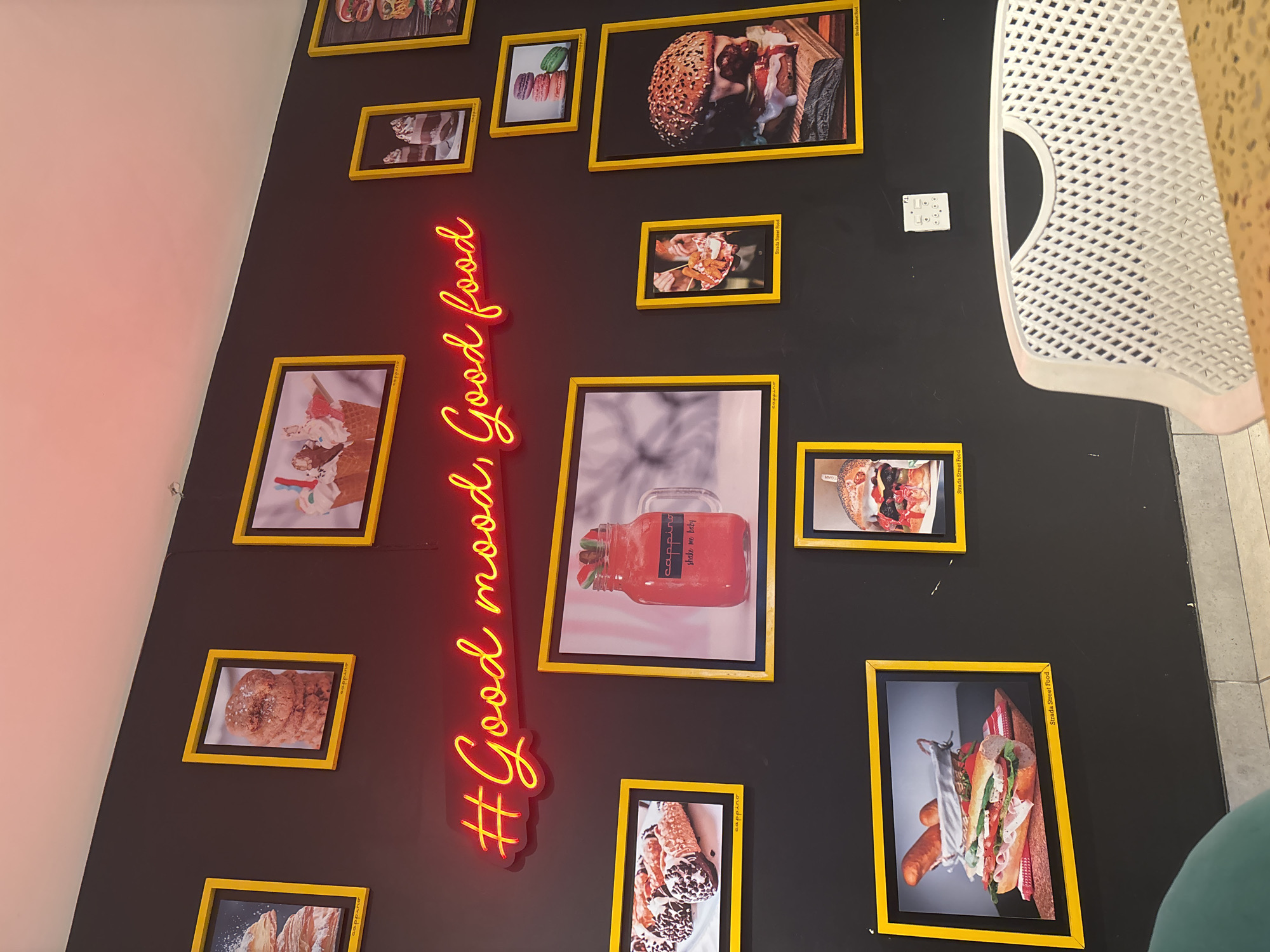 Neon food sign spotted on decorated wall in Durban