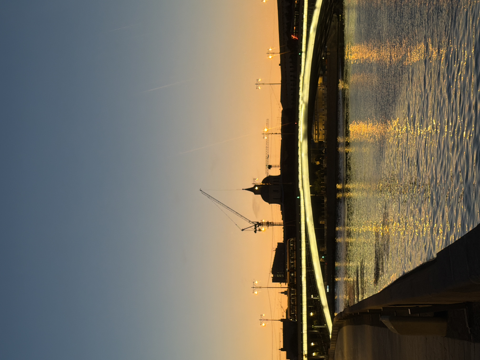 Passenger boat cruises the Moscow River at golden hour