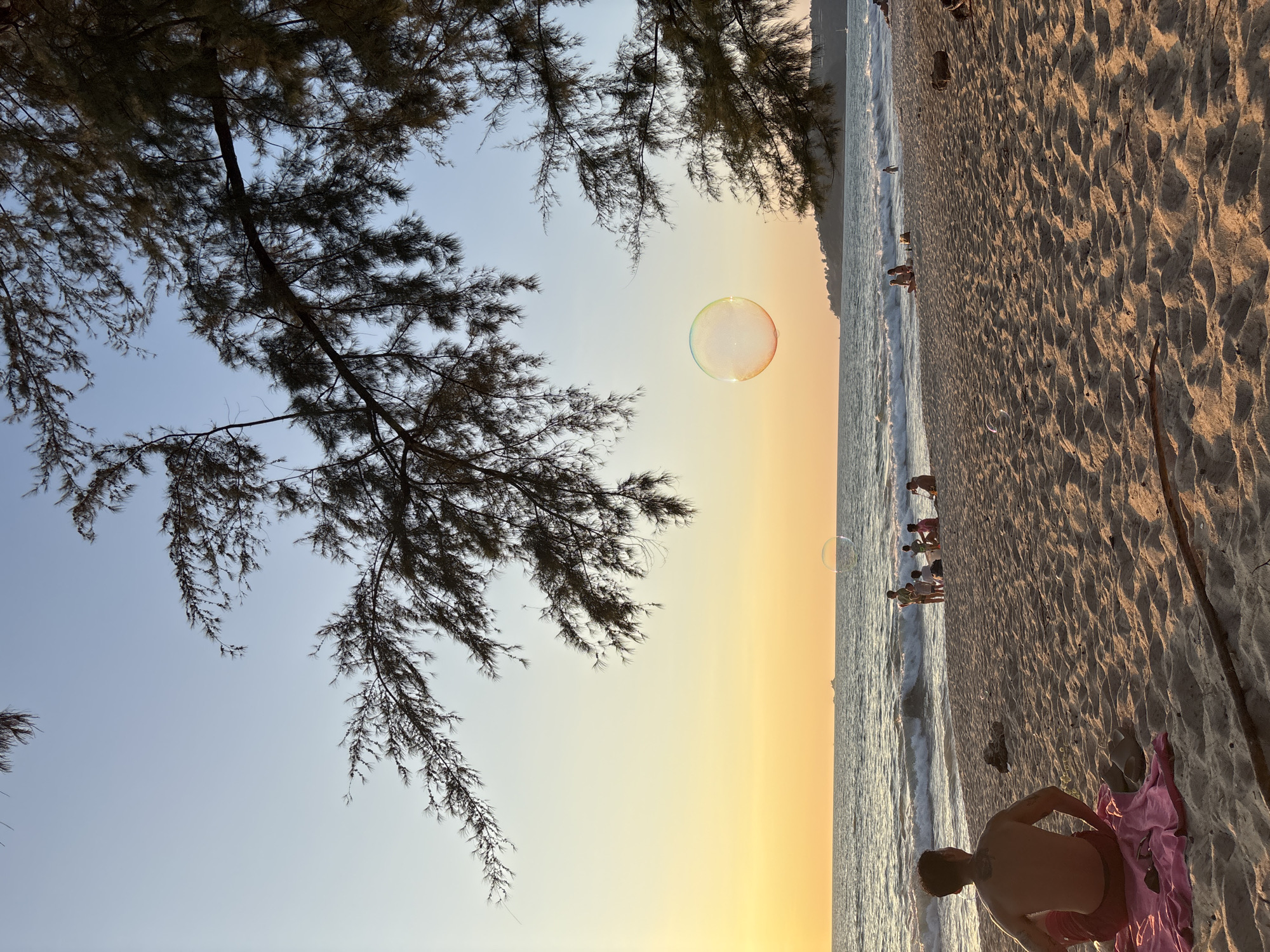 Person observed at sunset beach scene in Choeng Thale