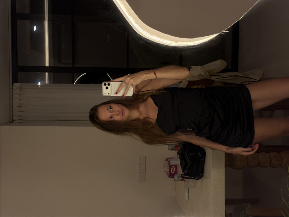 Woman takes mirror selfie in Indonesian hotel room