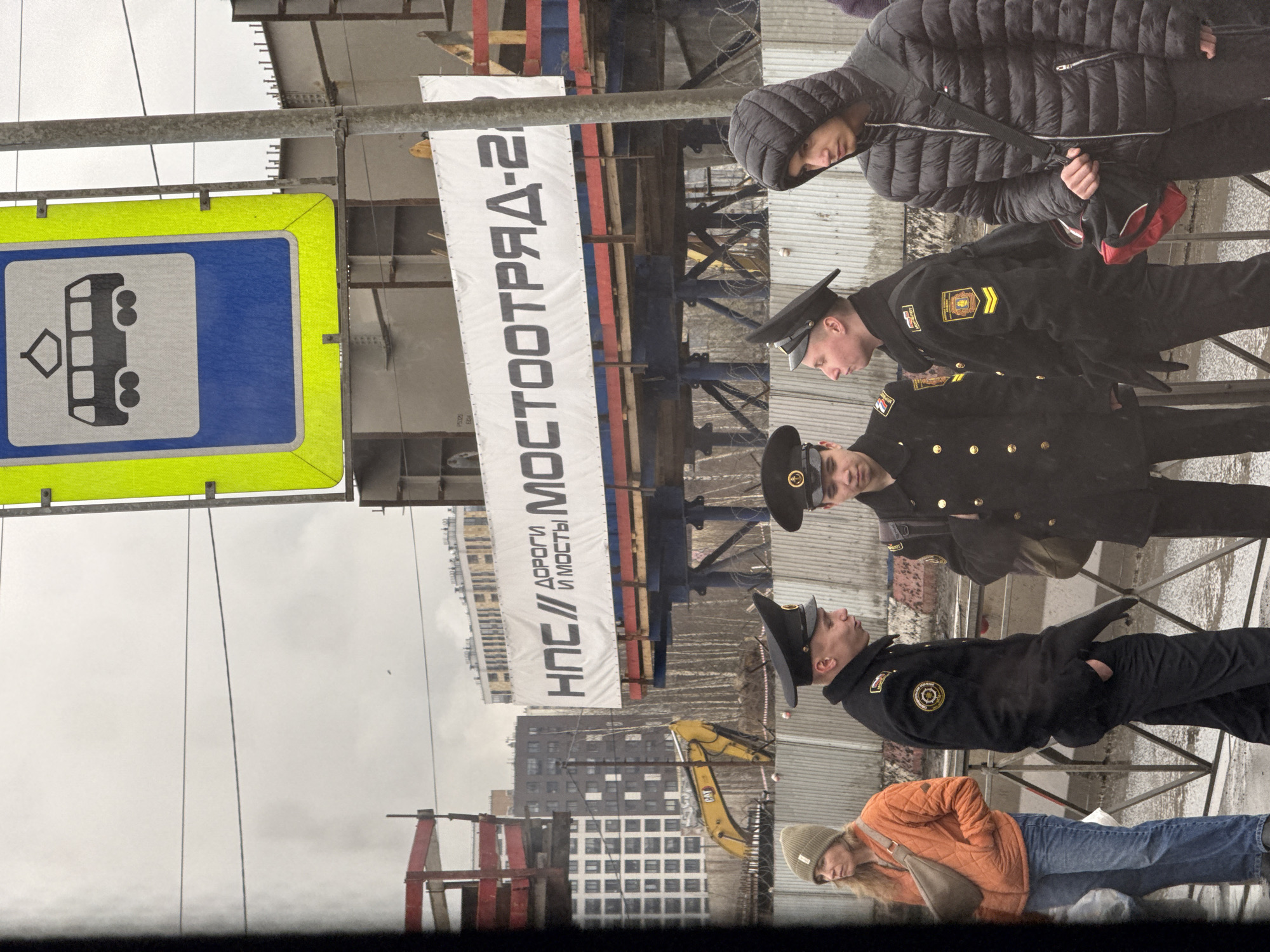 Uniformed officers, civilians gather on Saint Petersburg sidewalk