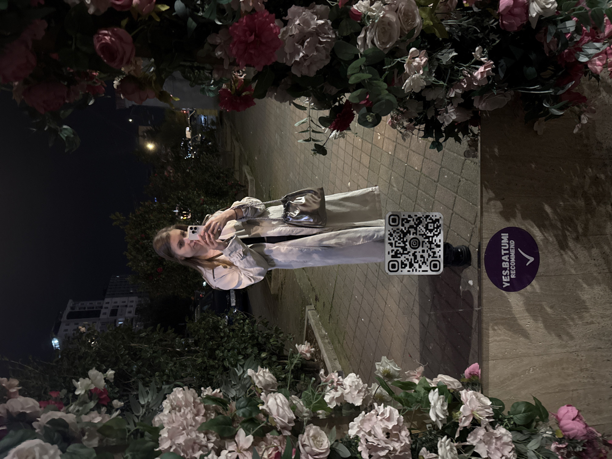 Woman takes nighttime selfie in downtown Batumi