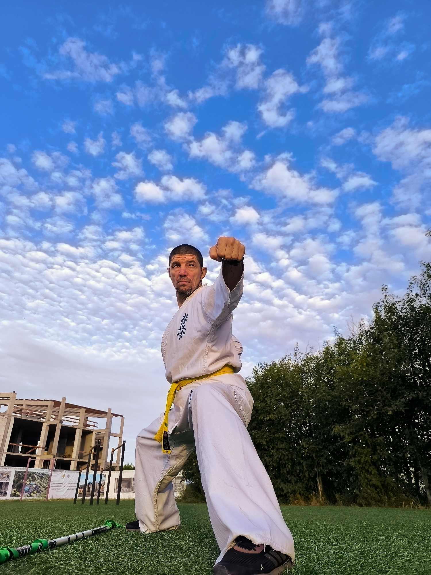 Yellow-belt karate practice on turf in Qarağandı
