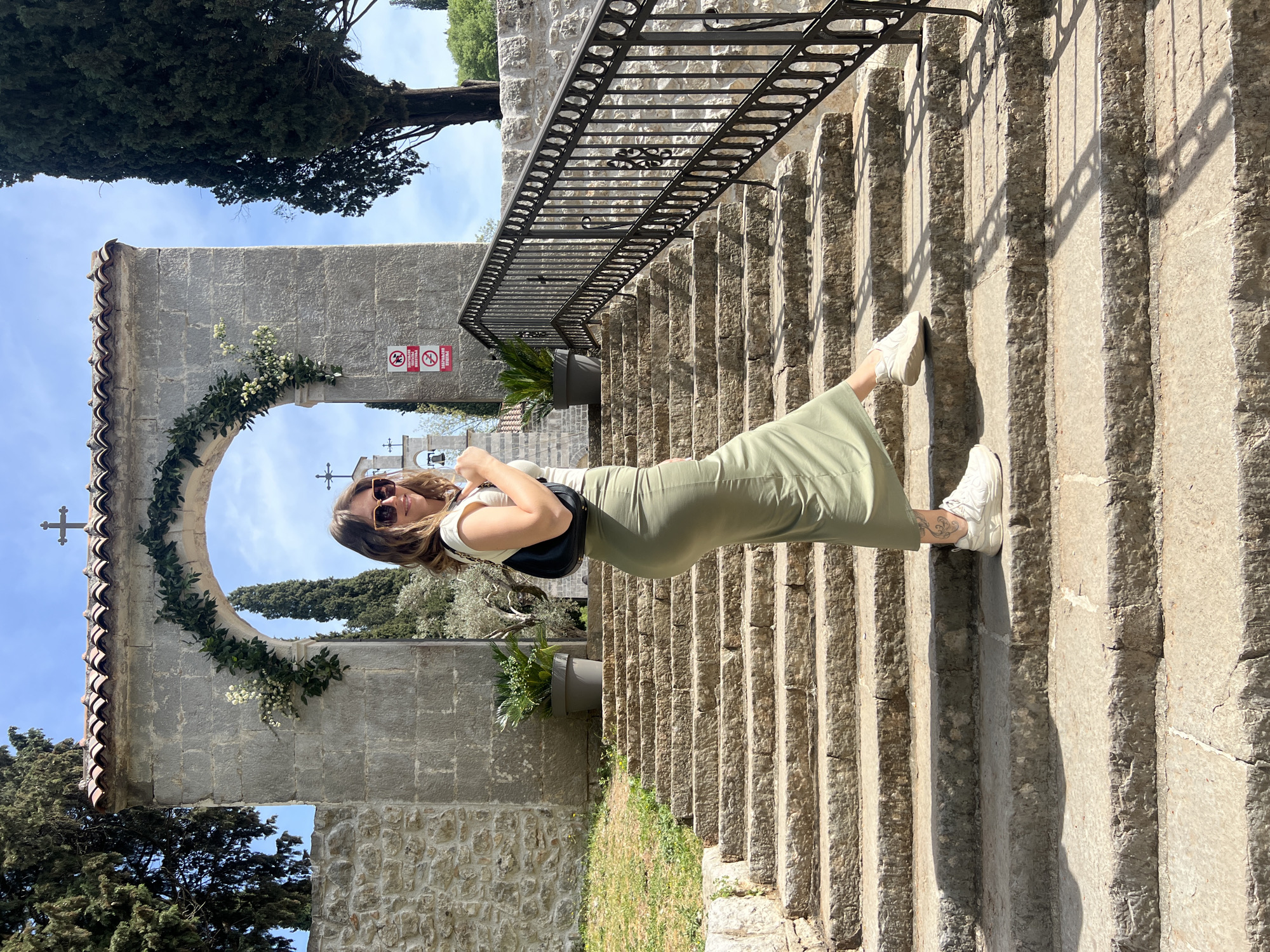 Woman in green dress spotted on stone steps in Podgorica
