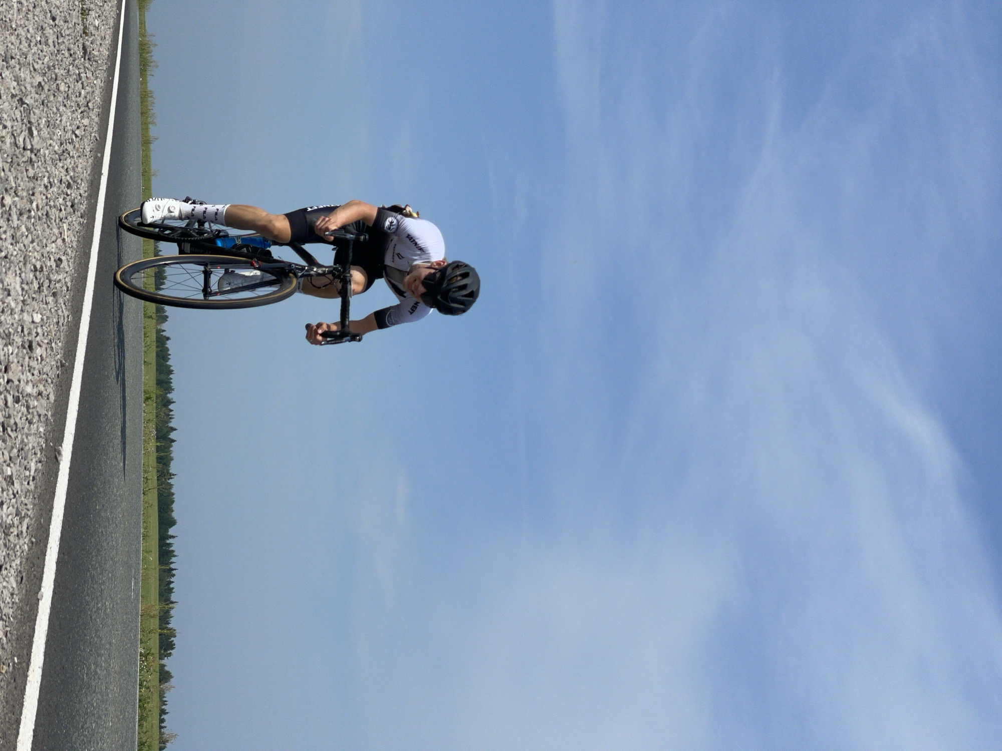 Organized road cycling race rolls through Perevoznoye with full support convoy