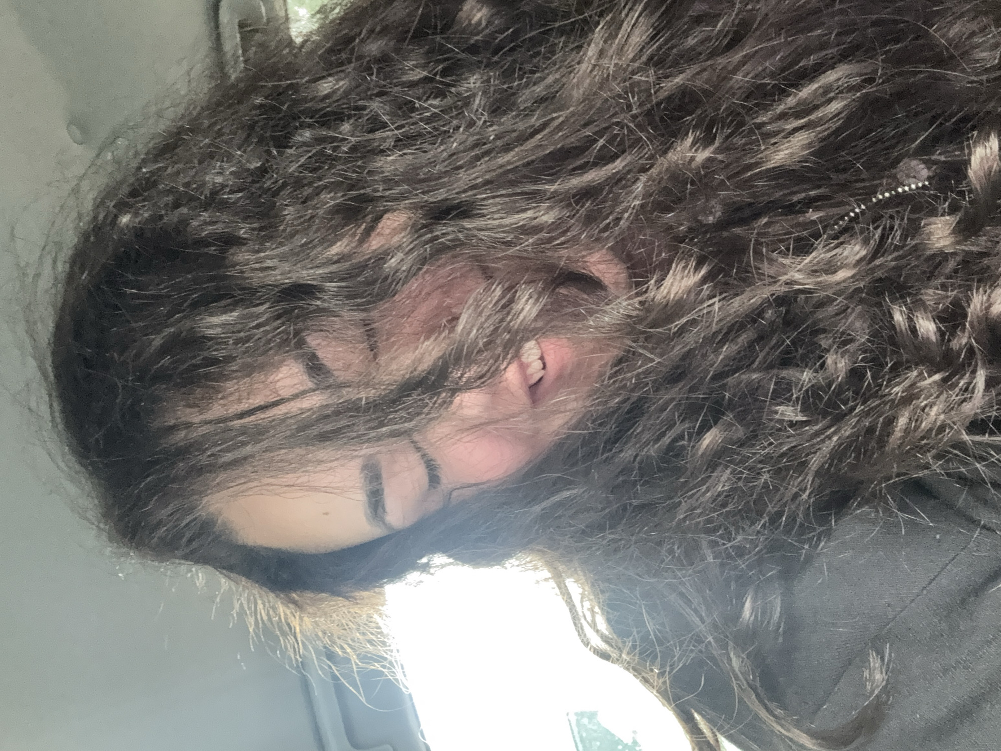 Woman takes morning selfies in car in Sofia