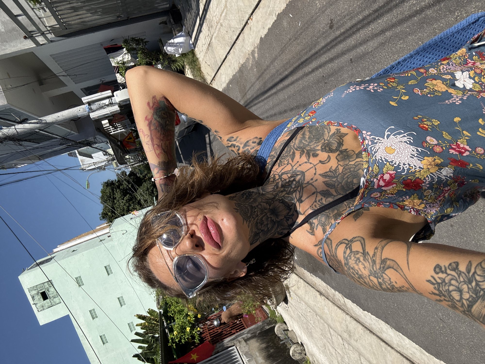 Woman records selfies near flag-decorated shops in Nha Trang
