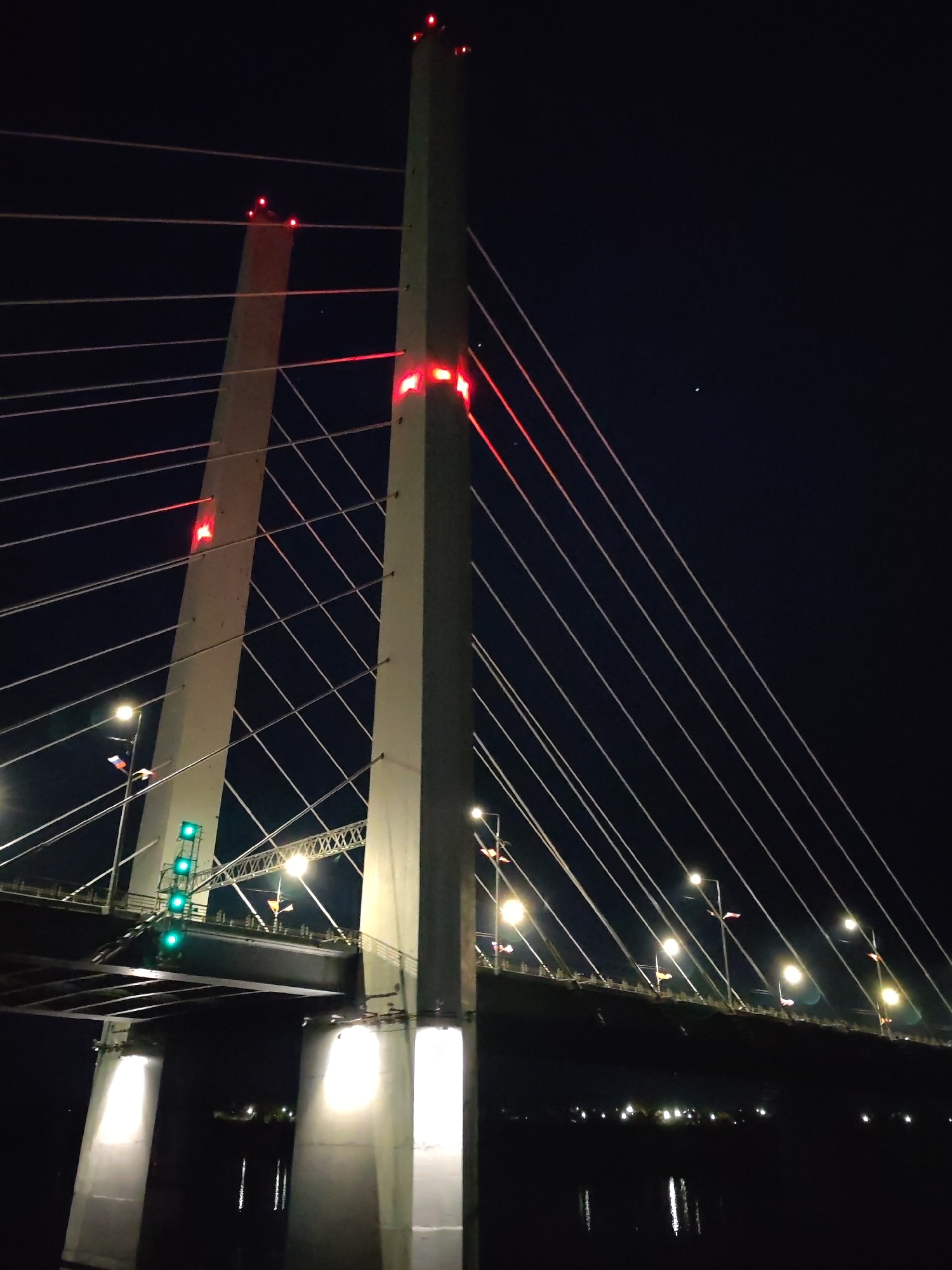 October Bridge illuminated red at night in Cherepovets